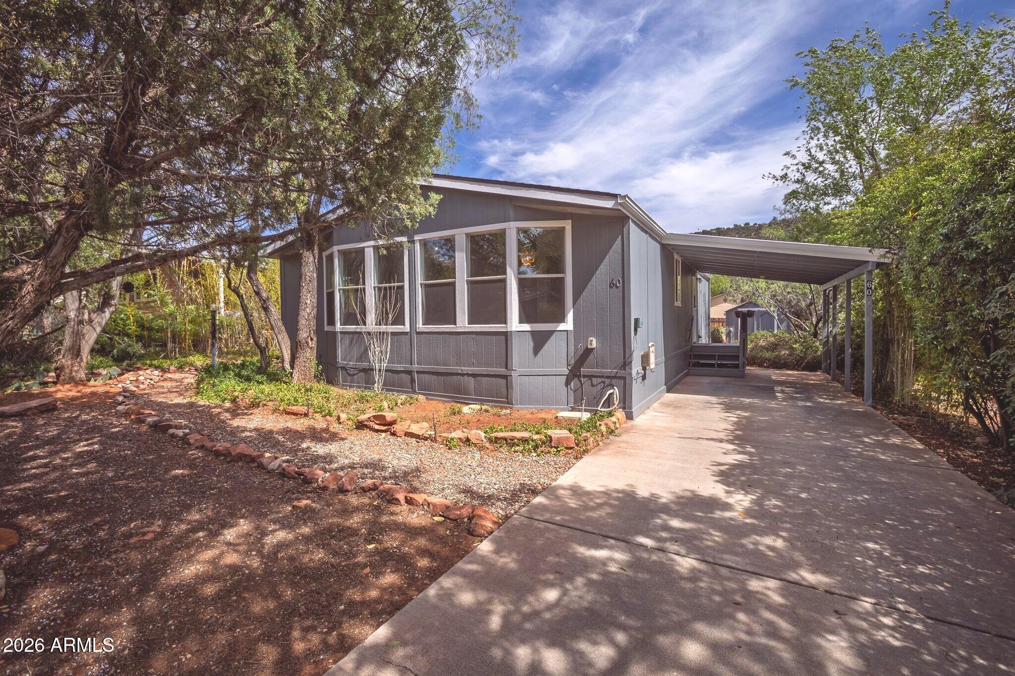 Tucked into a charming West Sedona neighborhood, this beautifully updated 2-bedroom, 2-bath home offers comfort and convenience just minutes from hiking and biking trails, restaurants, and shopping. A neighborhood trail at the end of the cul-de-sac leads directly to Sunset Park, featuring a playground, open field, and tennis/pickleball courts.  Great for active lifestyles. Freshly painted inside and out with new flooring, the home is bright and inviting. The living room features large windows for abundant natural light, while the kitchen offers generous counter space, a gas stove, and built-in microwave. The primary suite includes a full bath, walk-in closet, and private backyard access. Outside, enjoy a secluded yard with a shed which is perfect for a workshop or extra storage.