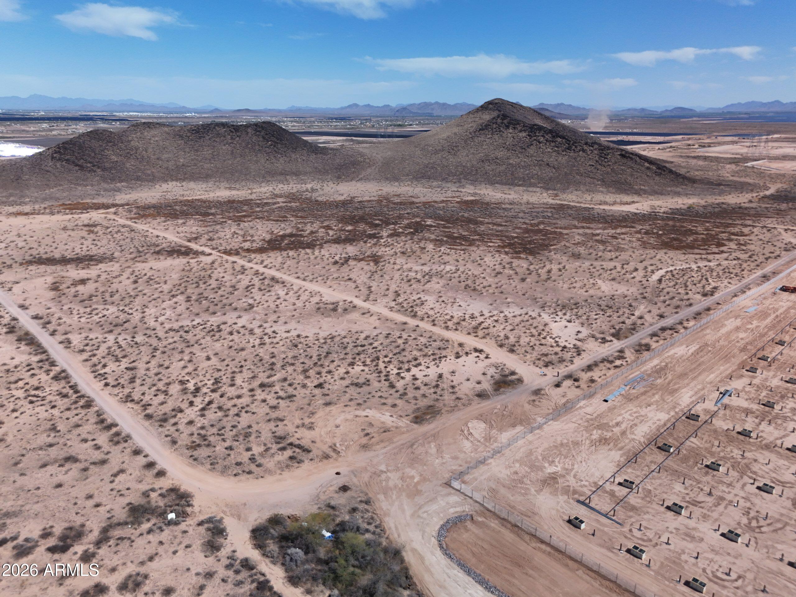 Most desert parcels come with a catch -- steep grading, rocky clearing, or zoning that boxes you in. This one doesn't. 5.02 flat acres in Maricopa County, ready for what you want to put on it. R-43 zoning gives you room to move: build a custom home, drop a manufactured home, or run livestock and small-scale ag. The terrain is flat Sonoran Desert with minimal clearing needed, so site prep is straightforward -- and with no HOA or CC&Rs, you're not waiting on anyone's approval to break ground. 5.02 acres | R-43 zoning | flat Sonoran Desert Access via dirt road (west boundary) APS electric available | well required (300-600+ ft) | standard septic | propane No HOA, no CC&Rs