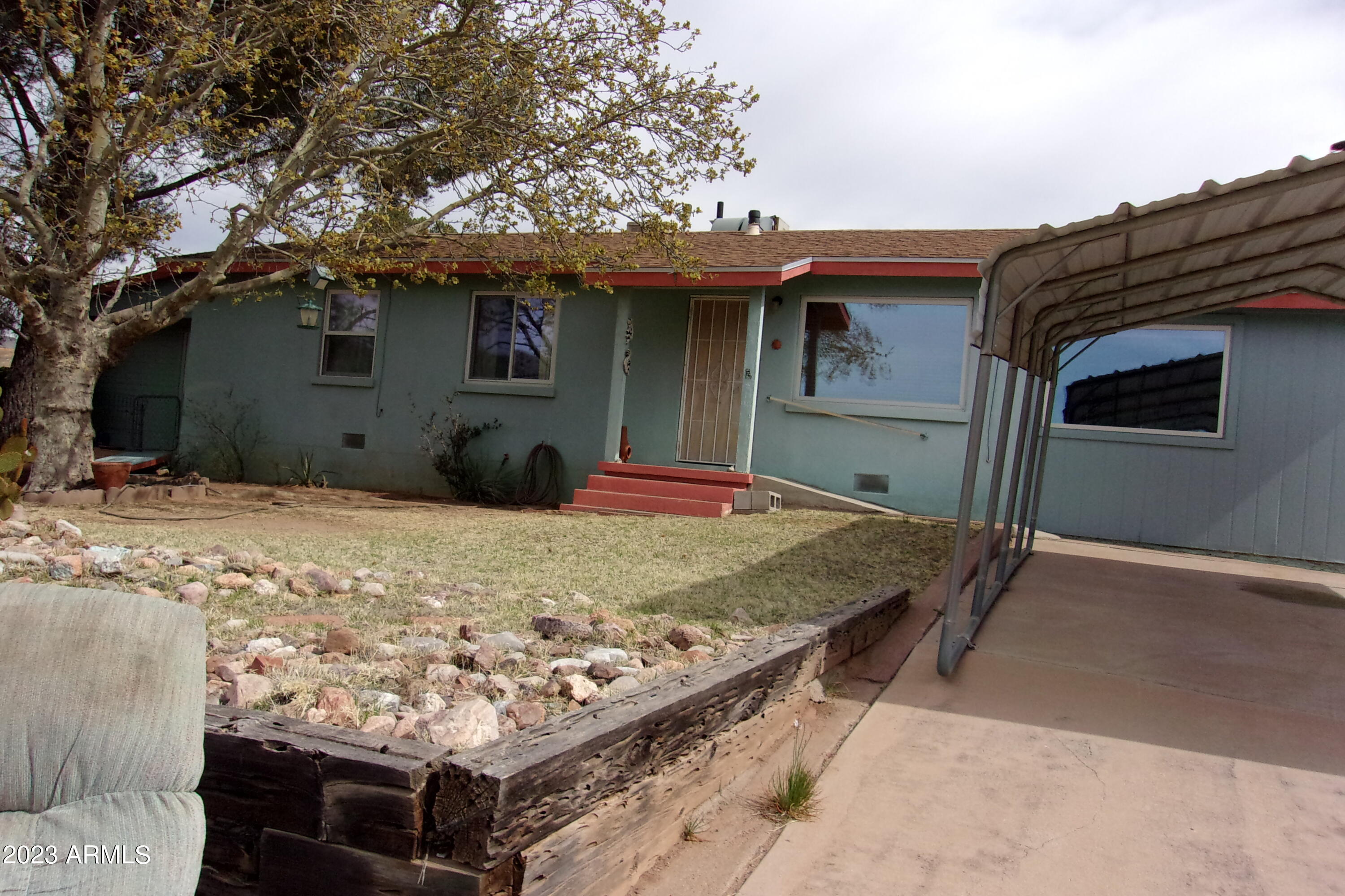 Enjoy the beautiful view of the San Jose Mountains from your front porch.  Three bedroom two bath. Wood floor some new paint interior.   New roof 2022 .Storage room with also work shop on side.  Nice yard small covered porch backyard area. Metal carport in front.