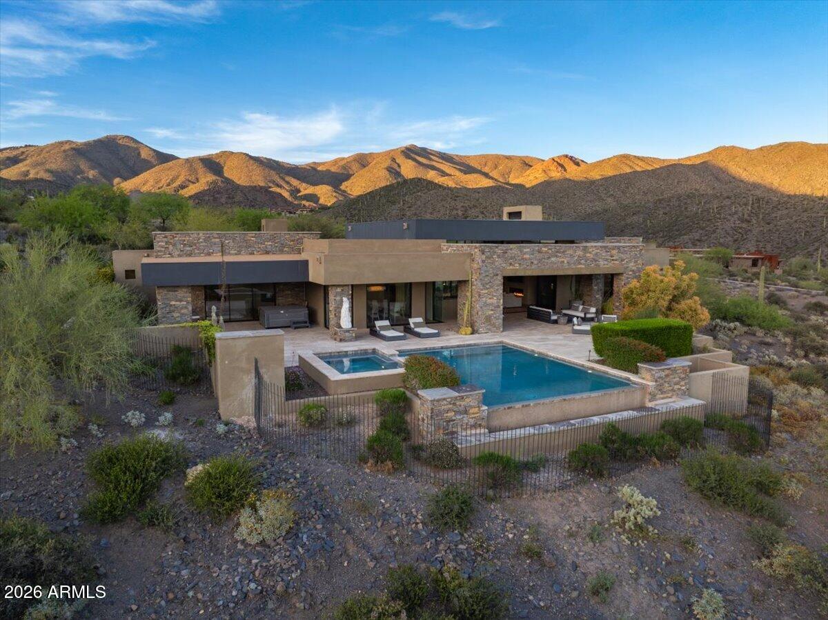 FULL GOLF MEMBERSHIP AVAILABLE. This is an exceptional opportunity to own a beautifully furnished estate tucked deep within in the prestigious Desert Mountain community. Situated on over four acres of pristine Sonoran Desert landscape, this rare property offers privacy, expansive views, and effortless single-level living with no interior steps. Designed for both comfort and entertaining, the home features a seamless open floor plan, generous living spaces, and windows that frame breathtaking desert, mountain, and sunset vistas. The chef's kitchen flows into spacious dining and great room areas, ideal for hosting gatherings or enjoying quiet evenings at home. The thoughtfully designed split floor plan provides luxurious privacy for owners and guests alike, with well-appointed bedroom suites The outdoor living is elevated with expansive patios, a resort-style pool and spa, multiple seating areas, and ample space to enjoy 
Arizona's year-round sunshine. This home is being offered furnished, furniture and furnishings are included in the purchase price.
