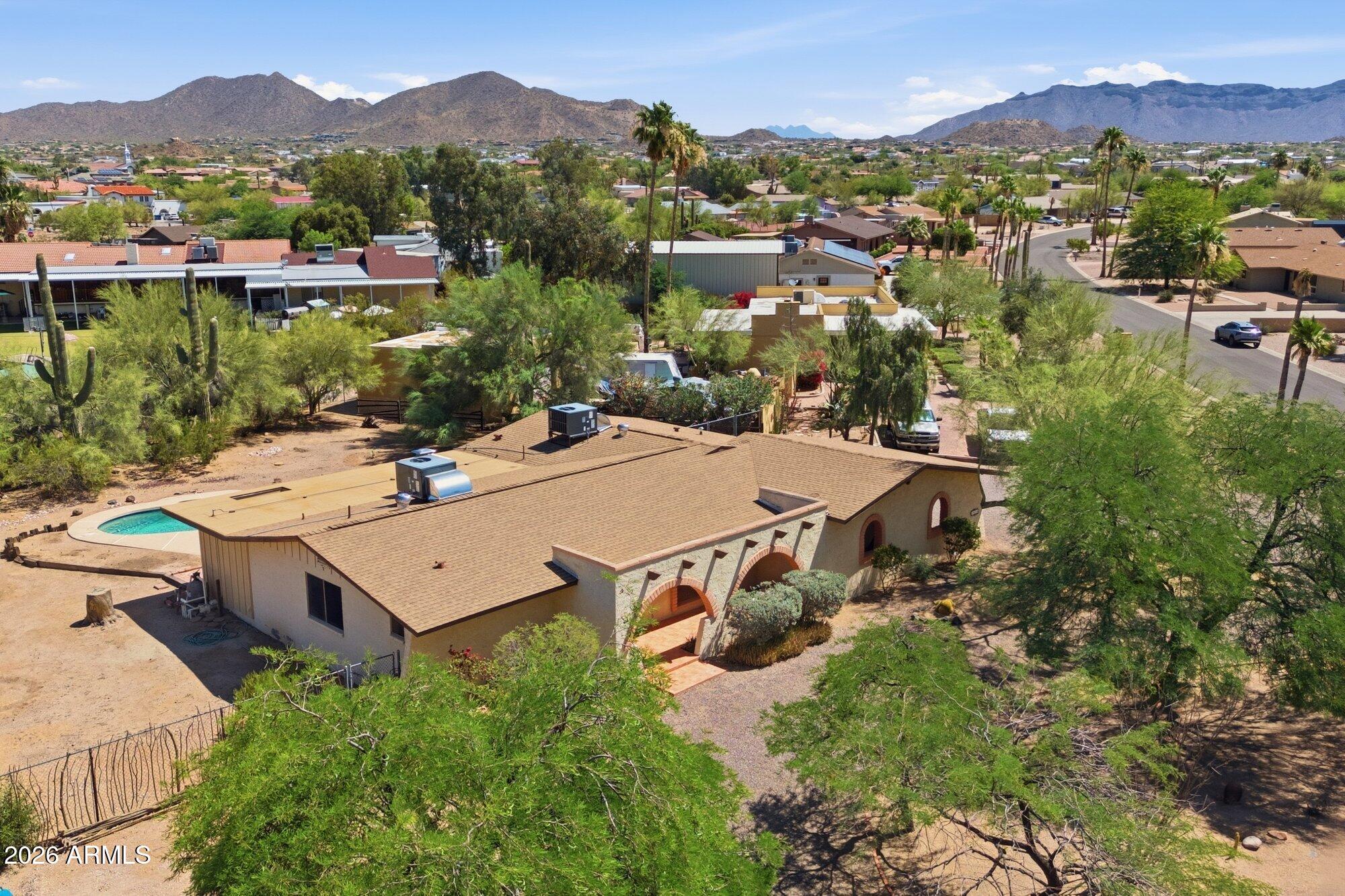 ARE YOU READY TO FALL IN LOVE? Sought after non-HOA neighborhood with huge homesites rarely offers an available home to the market.  Same owner since 1977. This custom home is nestled on a quiet street, set amidst towering mature shade trees, massive saguaros and lush desert foliage. Major upgrades include: Roof replaced 2026,  both heat pumps replaced 2024, Main bathroom remodel 2020.. Other upgrades: 2020: Hot water heater, 2020 Soft water loop 2021 Garbage disposal, 2022 SIMPLISAFE security system/Cloud Edge cameras, 2025 SRP electric meter, Recent 2026 professional home/termite/septic inspections.  Septic system is ADEQ compliant/certified   Priced aggressively and is offered in in AS-IS condition,  Seller will make no repairs or give allowances as a condition of sale.  WELCOME HOME~!!