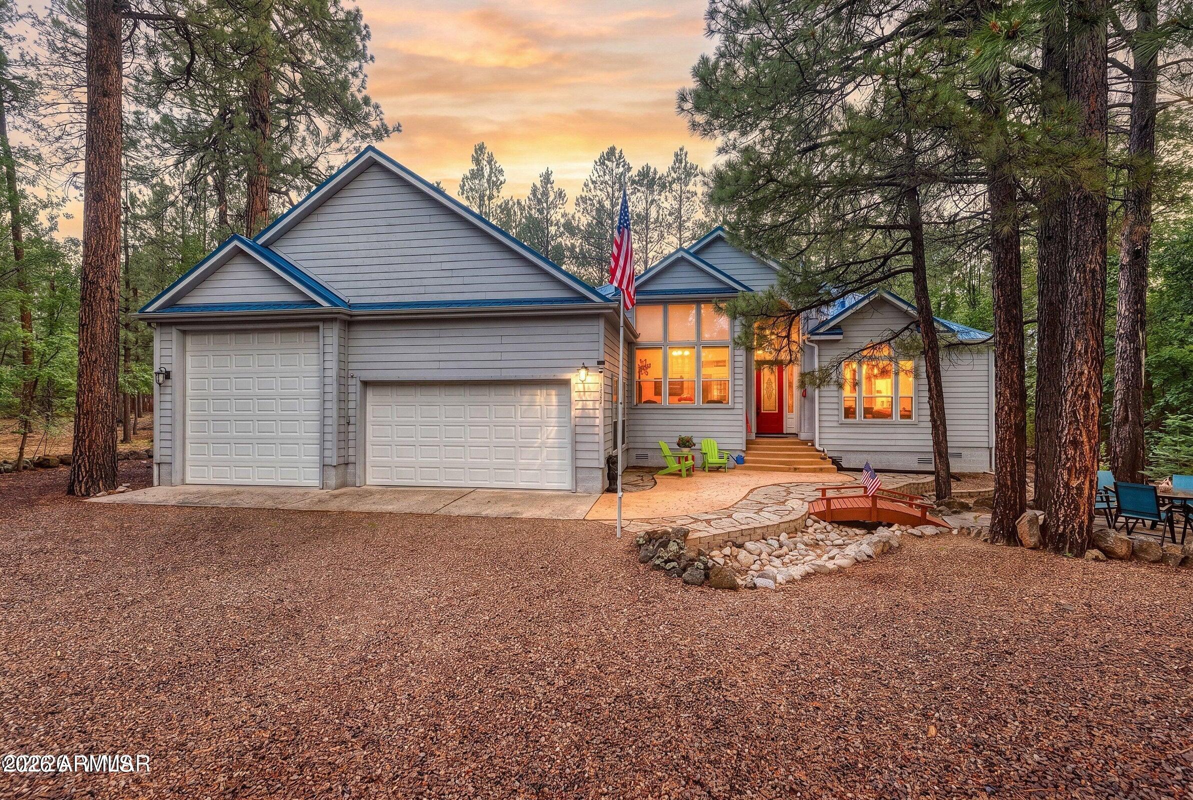 A MUST SEE! The Only Active Listing in the Neighborhood with Attached RV Parking! This beautifully maintained single-level home features an open great room with soaring 10-14 ft ceilings, walls of windows, ¾-inch Golden Ash hardwood floors, two gas fireplaces, six skylights, two solar tubes, Bose surround sound, and a kitchen with custom cherry cabinets and newer stainless steel appliances. The oversized 1,100 sq. ft. insulated garage includes a 42-ft attached RV bay with 30-amp hookup. Major 2020 updates include a new metal roof, water heater, and several windows. Enjoy the freshly repaired and painted back deck with a motorized awning. Fire-resistant HardiePlank siding and eco-friendly septic complete this rare offering!