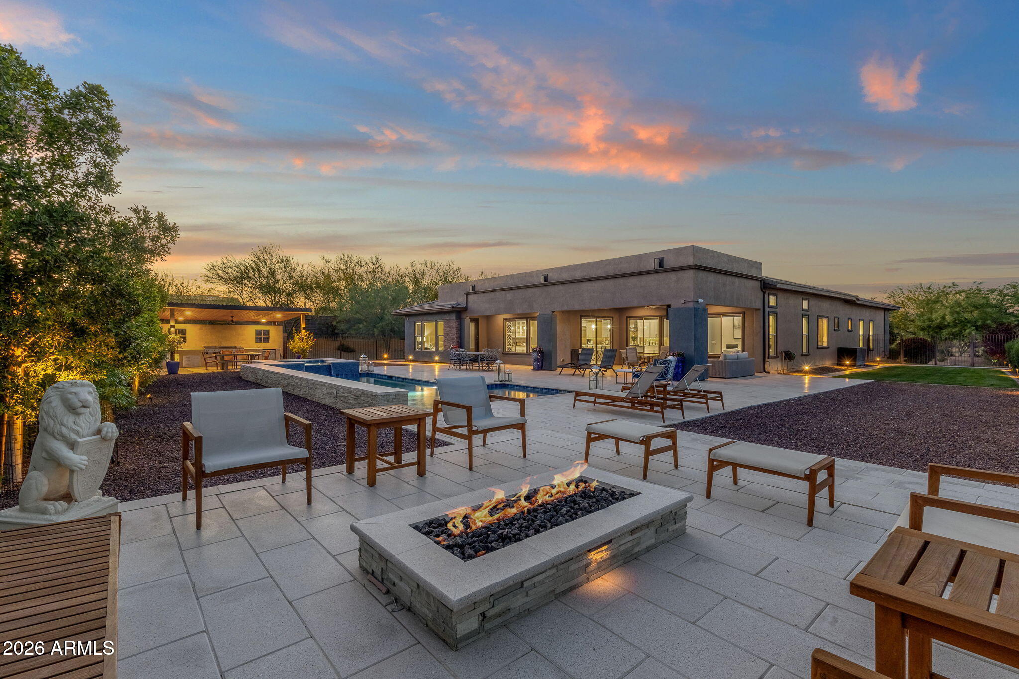 WOW! LOOK AT THAT PRICE!! Guard gated, modern desert luxury with attached casita in Rio Verde (just minutes from nearby, bordering Scottsdale), located in Trilogy at Verde River Golf & Social Club. This single-level Dorado model offers 3 bedrooms, 3.5 bathrooms, + a separate office, + a bonus room off the primary bedroom, with 3,480 sq ft on a rare ~1/3-acre lot!! The owners spent several hundred thousand dollars in backyard upgrades alone including 3,500 sq ft of artistic pavers, luxurious pool & spa, huge ramada with outdoor BBQ kitchen, and raised fire pit sitting area to take advantage of the FOUR PEAKS mountain views. Also, the house is pushed far to the west side of the lot allowing for a large side yard and is the only lot with an HOA approved 10' side gate. This lot is ELEVATED and very PRIVATE, as you can't see your neighbors & they can't see you. Situated on a north/south exposure lot bordering a common area, the home features a clean contemporary exterior, paver driveway, and desert landscaping with some natural grass in the backyard.  Inside, an open-concept great room floor plan is highlighted by 12+ flat ceilings, no interior steps, expansive ENERGY STAR qualified low-emissivity windows, and abundant natural light. The chef's kitchen includes a large island with seating, custom cabinetry, LEATHERED granite counters, built-in appliances, flowing seamlessly into the dining area and great room. The primary suite offers a spacious retreat with direct outdoor access. The attached casita includes a private bedroom, full bathroom, sitting area, and kitchenette, ideal for guests, multi-generational living, or flexible use. An additional den/office offers a dedicated workspace or flex room. Located within a gated golf community with access to biking and walking paths, clubhouse, community spa and heated spa, tennis courts, pickleball, workout facility, and concierge services. Nearby access to Tonto National Forest (1.3 miles), Needle Rock Recreation Area (4.6 miles), and McDowell Mountain Regional Park (8.4 miles) offers hiking, biking, and outdoor recreation, with additional golf opportunities at Trilogy Golf Club at Verde River (0.1 miles). Also, within reach of North Scottsdale dining, shopping, and entertainment. A private desert retreat offering modern design, flexible living, and access to golf and the perfect Arizona outdoor lifestyle you've been looking for!