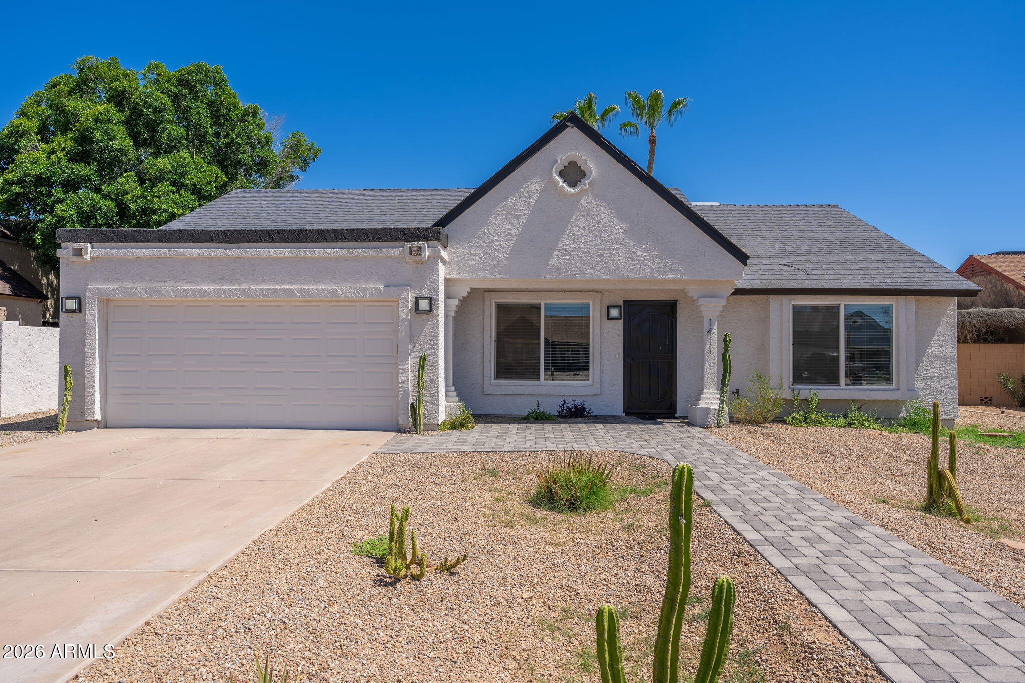 Completely renovated in 2021, this  3-bedroom, 3-bath residence blends contemporary design with warm modern style. With no HOA and over $100,000 invested in a spectacular backyard transformation completed in 2025, this home offers the perfect combination of style, comfort, and functionality.
From the moment you enter, you'll appreciate the thoughtfully redesigned open-concept floor plan featuring vaulted ceilings, a  floor-to-ceiling fireplace, and seamless flow between the living and family rooms. Wide-plank wood-look flooring, designer finishes, and natural light to create an inviting atmosphere throughout. 
The gourmet kitchen serves as the heart of the home, showcasing custom cabinetry, quartz waterfall countertops, stainless steel appliances, an oversized walk-in pantry, under-cabinet LED lighting, a built-in Lazy Susan, concealed outlets, and a pop-up electrical and USB charging station on the expansive peninsula. The spacious primary bedroom features a spa-inspired bathroom plus a generous walk-in closet. Two additional bedrooms provide flexibility for family and guests, including a desirable ensuite bedroom with its own private bath. 
Designed for both everyday living and entertaining, the home offers a formal dining room, a casual breakfast nook, and indoor-outdoor connectivity. Step outside to the resort-style backyard, where a newly constructed pool, above-ground spa that also functions as a cold plunge, and beautifully updated outdoor spaces create the ultimate Arizona lifestyle experience. 
The upgrades continue with an epoxy-coated garage floor and a versatile detached, climate-controlled small studio complete with electricity and its own A/C unit. Ideal as a home office, fitness studio, art space or workshop, it offers separate access from the front of the property. 
Installed in 2025 a 10,000-gallon custom saltwater pool featuring a full travertine deck and Baja sun shelf. Includes dual laminar water features and a 3-foot waterfall accented with glass tile detailing. Equipped with a premium Pentair variable-speed pump, Intellicenter, Wifi, LED lighting, cartridge filtration system, and salt water generator.
Also installed in 2025 Bellagios Spas, Capri hotub -upgraded with Wif-fi controls and high efficiency Gecko in.temp heat pump system with both heating and cooling capability, allowing use as either a traditional hot spa or refreshing cold plunge. 
The patio is pre-plumbed and pre-wired for a misting system, with water and electrical connections already in place for easy future installation.
Conveniently located with easy freeway access, close proximity to shopping, dining, and Arizona State University, this turnkey property combines exceptional design, quality craftsmanship, and modern amenities.
