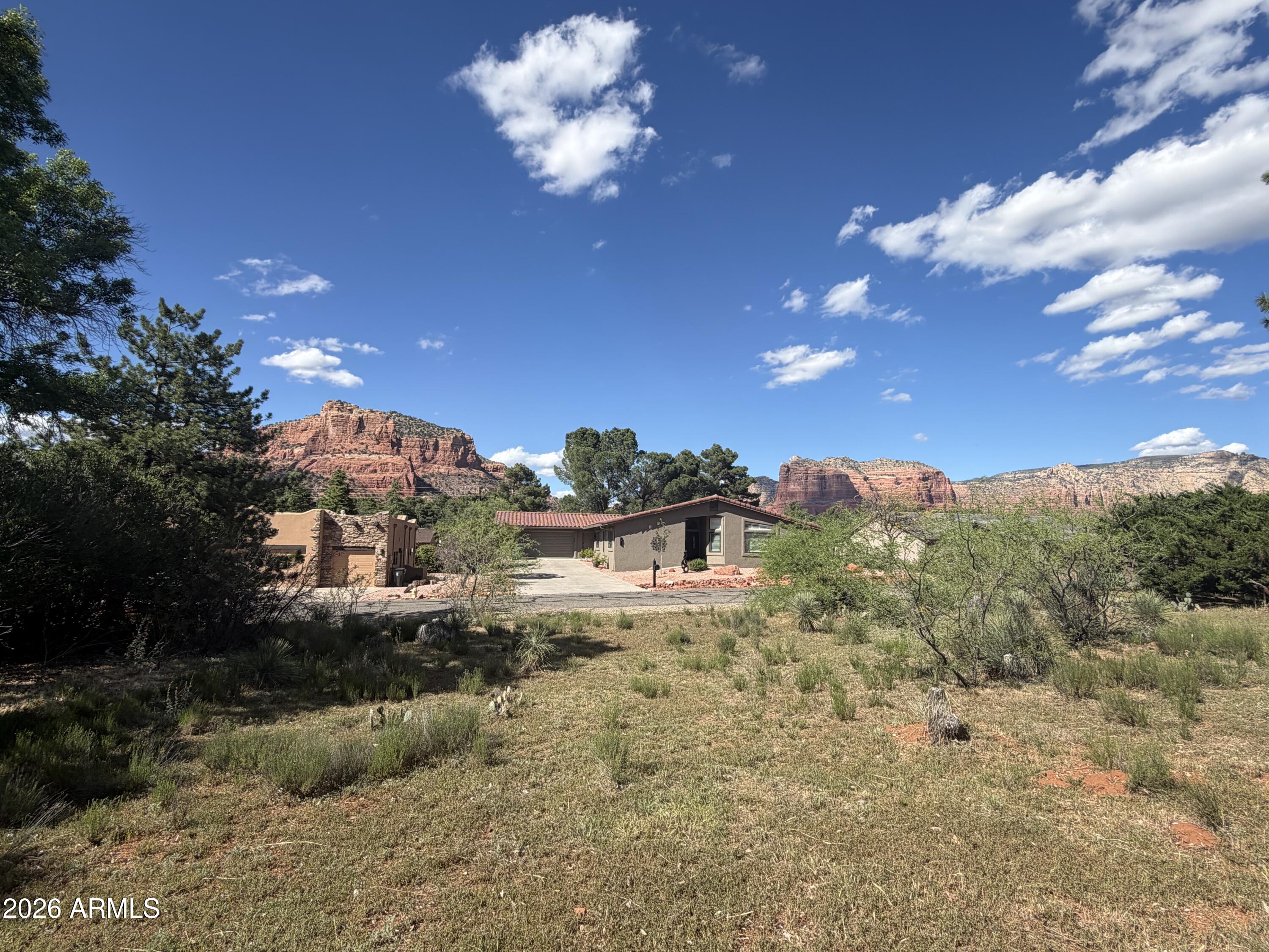Gorgeous quarter-acre homesite in Village of Oak Creek offering stunning north-facing views of Bell Rock, Cathedral Rock, and Courthouse Butte. Nestled in Oak Creek, serene setting, this sought-after Sedona community is known for its relaxed lifestyle, breathtaking red rock scenery, and endless access to hiking and outdoor recreation.

All utilities are available at the street, making this an easy and cost-effective build opportunity. Located within a designated dark sky community, Starlight Way truly delivers unforgettable night skies. Don't miss one of the last premium, build-ready lots in beautiful Sedona.
