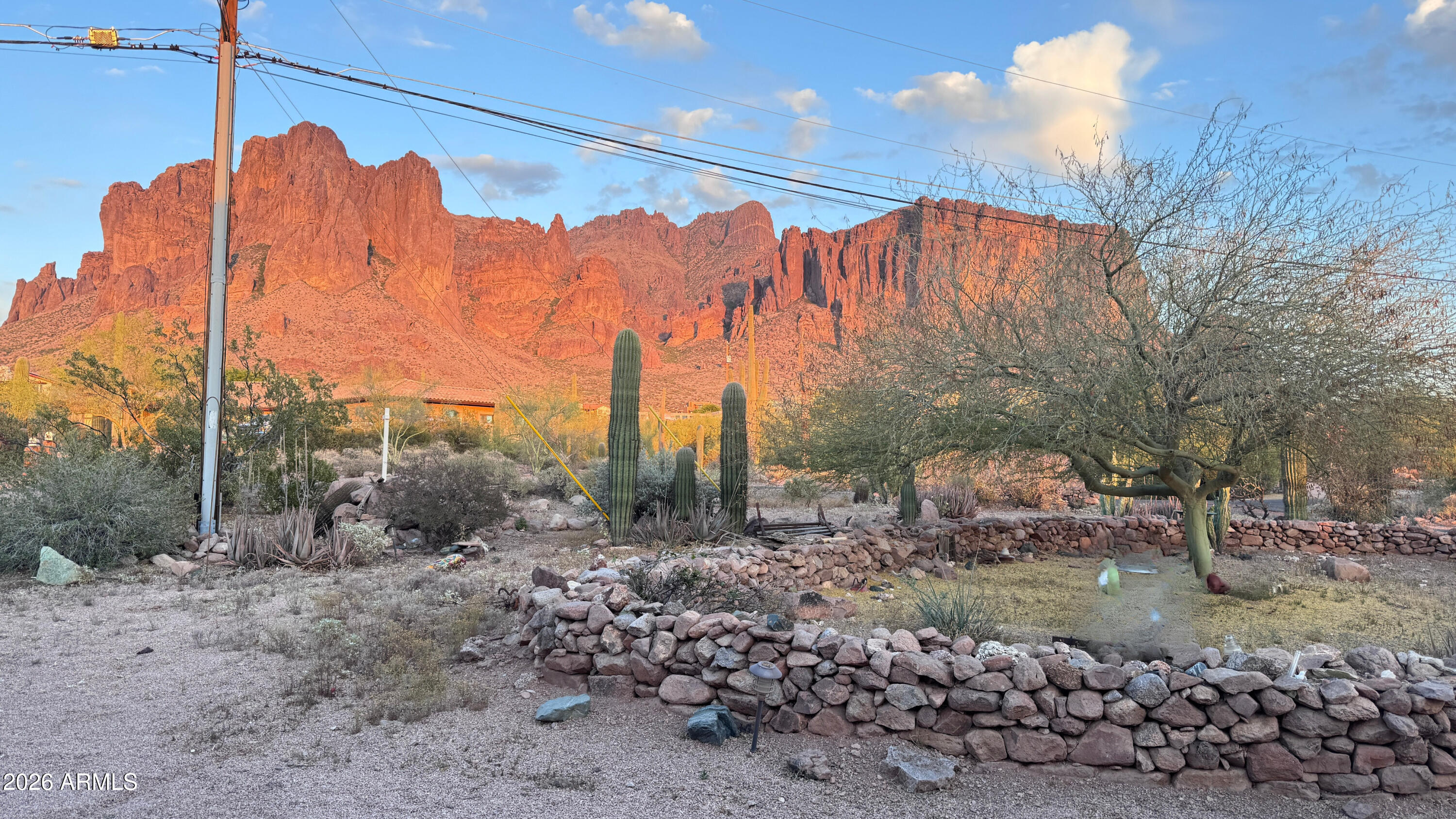 TRULY ONE OF THE BEST LOTS IN THE MINING CAMP AREA! Situated on a premium 1.25-acre corner lot with dual street frontage, this property offers breathtaking 360-degree views including stunning city lights and endless Arizona skies! This 4-bedroom, 2-bath home was extensively remodeled approximately 5 years ago, featuring tile flooring throughout, granite countertops, updated bathrooms, fresh interior paint, and some newer windows. A brand new A/C installed in 2025. The exterior presents an incredible opportunity--left in natural desert condition, it's a blank canvas ready for your vision. Create your dream outdoor space, add landscaping, or keep it low-maintenance while enjoying the wide-open views and privacy. Perfect for those needing space and freedom with NO HOA this property includes RV parking with hookup, 3 storage buildings, and a 3-car garage, plenty of room for all your toys, equipment, and hobbies. Whether you're looking for a full-time home, investment, or a property you can customize to your taste, this one has unmatched lot value, views, and potential!