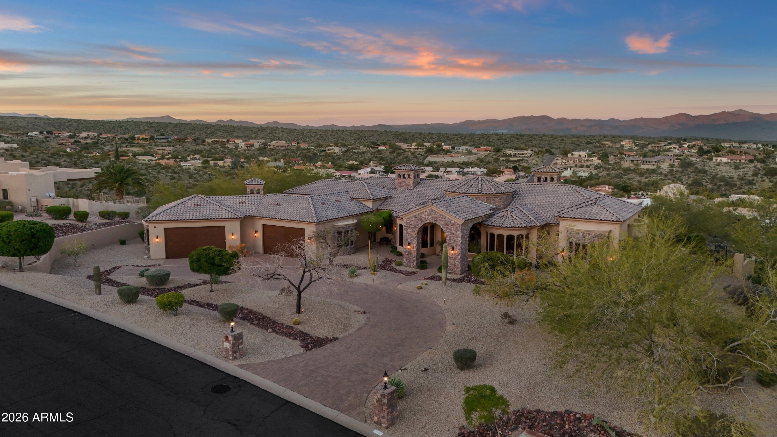 From the moment you arrive, the views define the experience. Set on over three acres on one of Fountain Hills' most prestigious ridges, this architecturally rich desert estate commands breathtaking panoramas of the surrounding mountains and iconic Four Peaks—views that greet you upon entry and remain ever-present throughout the home.

Designed for privacy and effortless single-level living, the residence is thoughtfully oriented to embrace its extraordinary setting. Expansive living spaces unfold with intention, creating a natural flow that feels both grand and inviting. Warm architectural details, timeless materials, and carefully framed sightlines ensure the landscape is never an afterthought, but a constant companion to daily life.

The heart of the home is anchored by gathering spaces that invite connection, whether for intimate moments or elegant entertaining. Walls of glass draw the outdoors in, while indoor spaces transition seamlessly to outdoor living areas designed to celebrate the scale and beauty of the desert. From sunrise to sunset, light and color move across the horizon, transforming the home throughout the day.

The primary suite offers a serene retreatprivately positioned to capture the views while providing a sense of calm and seclusion. Additional guest suites and flexible living spaces are thoughtfully placed to offer comfort, privacy, and versatility, each enjoying a relationship with the surrounding landscape.

Outdoors, the experience is nothing short of extraordinary. A dramatic double negative-edge pool and spa appear to spill into the desert beyond, creating an immersive vantage point for reflected sunsets and sweeping vistas. Multiple patios and gathering areas provide endless opportunities to pause, entertain, or simply take in the stillness and scale of the setting.

This is a residence where architecture and landscape exist in perfect balancea rare opportunity to own an architecturally rich estate defined by space, privacy, and truly unforgettable views.