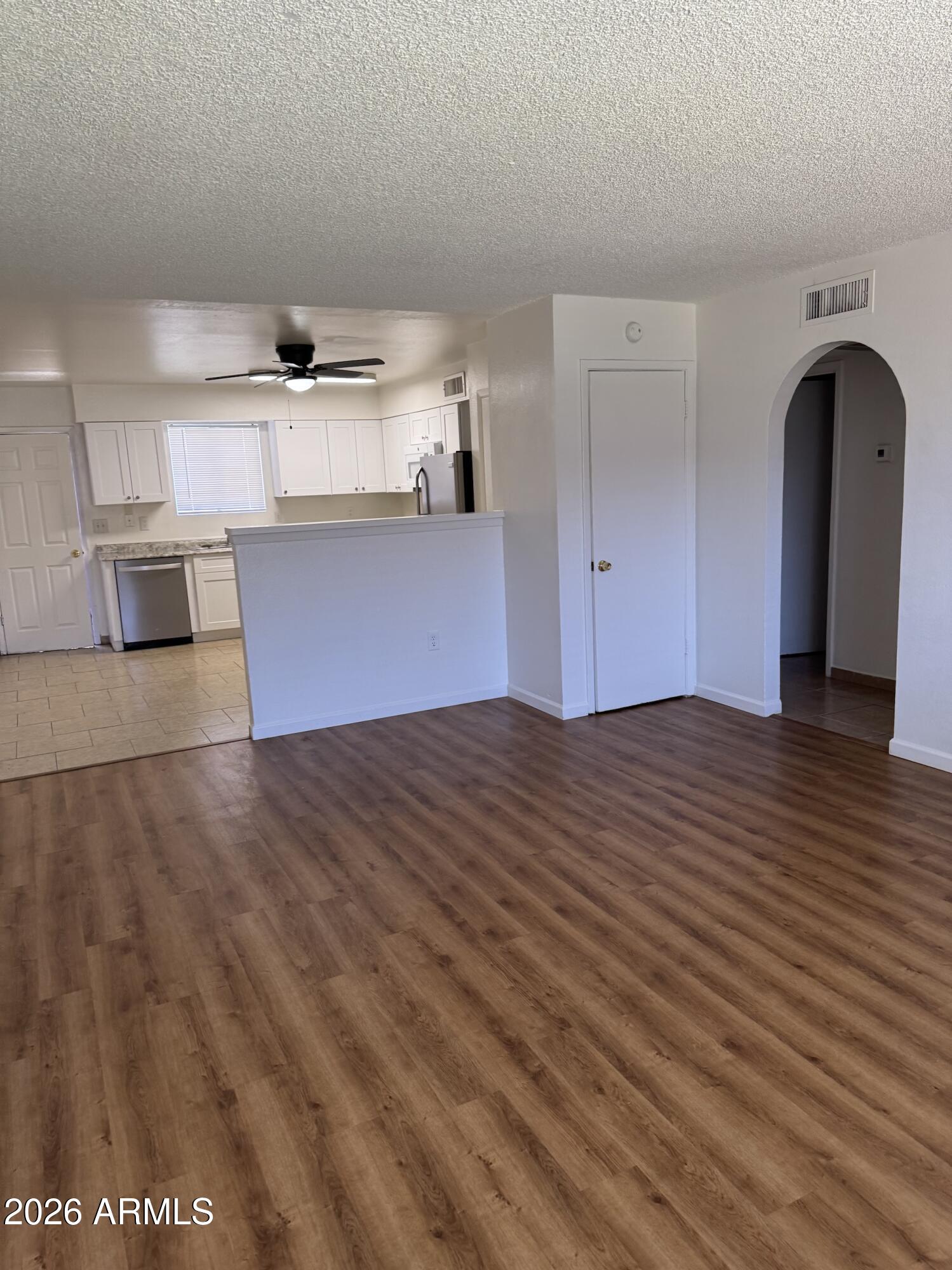 Terrific first-time home or buy-and-hold rental. This property is very resilient with ceramic kitchen tile, laminated wood flooring in the living room, and bedrooms. Shaker kitchen cabinets and granite-looking Formica. This home has a beautiful bathroom. In a private townhouse community, with a lovely small yard, washer and dryer hookup in a large storage room off of the covered parking area for 2 vehicles. Newer A/C, Brand New Water Heater, and the flat roof was re-coated in 2022