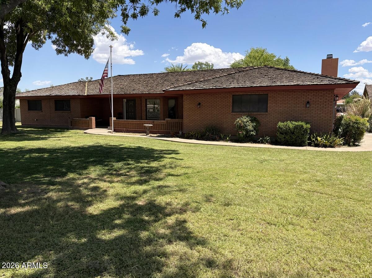 Single-story ranch on 1.25 irrigated acres w/horse privileges, NO HOA, and room for everything. 4 bedrooms, 3.5 baths, 3,046 sq ft. Two master suites, each with full bath and patio access. Walk-in closets in every bedroom. Vaulted wood cathedral ceiling in family room with wood-burning brick fireplace. Granite kitchen with reverse osmosis system. Tile, Carpet, and wood flooring throughout. Covered cedar patio spans ~12x54 ft across the back. Private pool. Fenced yard with/shade trees -- fully irrigated front and back. 2-car attached garage plus detached 1,600 sq ft workshop with 110/220 electrical and 2-car parking. RV gate and RV parking. New hot water heater (2024). Shake roof resealed. Solar screens.