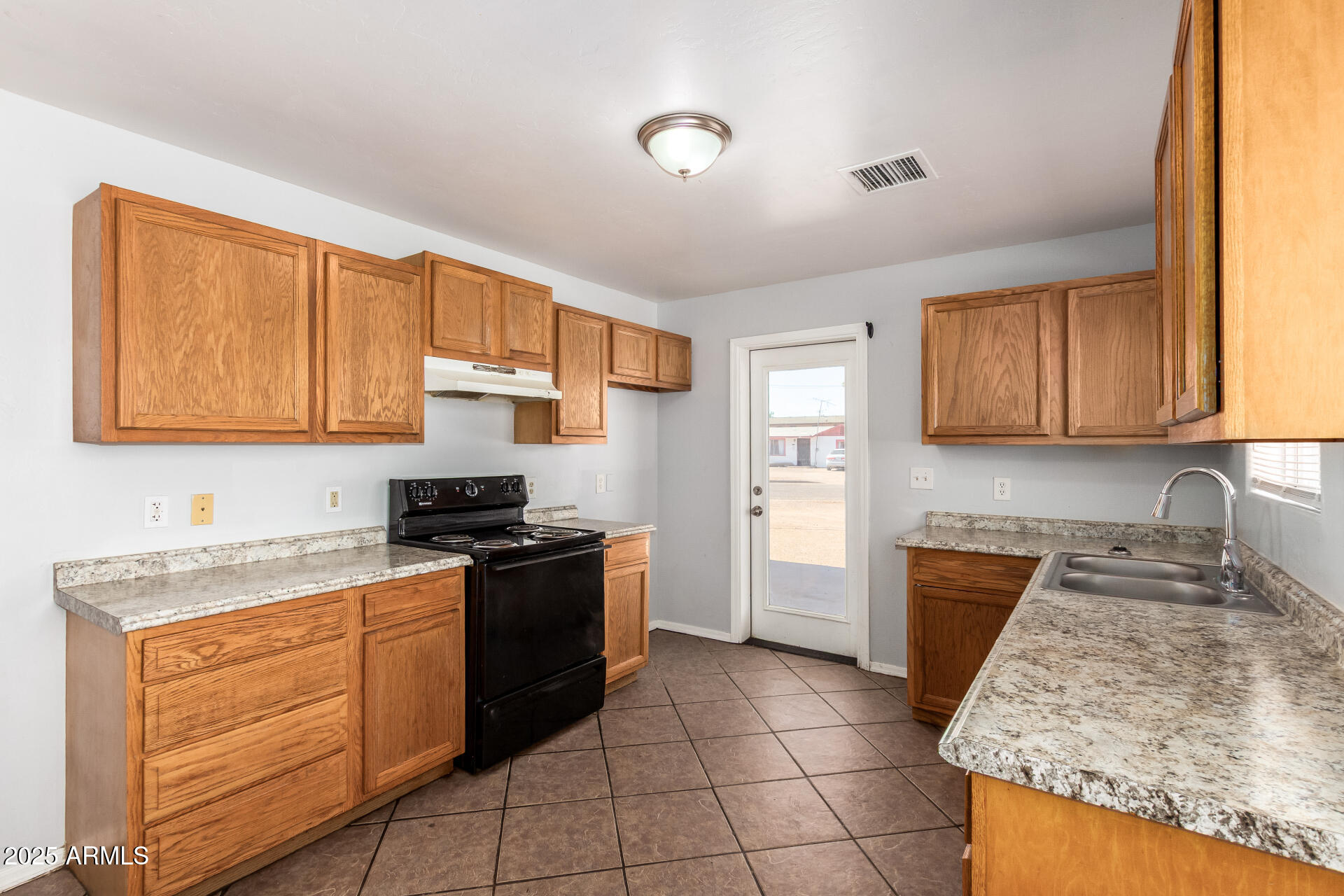 MOVE IN READY!! , NO HOA, This charming 3-bedroom, 2-bath home sits on a desirable corner lot in the heart of Eloy, AZ. Featuring an open floor plan, bright kitchen with plenty of cabinets, and tile flooring throughout. This home offers comfort and convenience at a great value. Enjoy a low-maintenance yard, carport, and RV access--perfect for extra parking or outdoor projects. The location of this home is walking distance to schools, parks, and shopping.  Tour this home today.