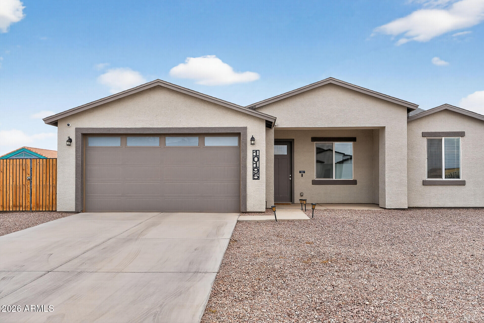 Step inside this beautifully crafted 2022 single level home and instantly feel the sense of calm that comes from thoughtful design and open, airy spaces. With 9 foot ceilings, natural light pouring in, and a layout that flows with ease, this 4 bed, 2 bath residence feels like the kind of place where life slows down just enough for you to savor it. The heart of the home is its spacious great room and modern kitchen complete with granite countertops, a generous island, and stainless steel appliances. Whether you're hosting Sunday brunch or enjoying a quiet morning coffee, this space is designed to bring people together. The split primary suite offers a peaceful retreat, featuring a beautifully tiled walk in shower, double vanity, and a roomy closet that makes everyday living feel effortless. Three additional bedrooms give you the flexibility to create a home office, guest space, or playroom.  Whatever your season of life calls for. Step outside to a large 7,341 sq ft lot with complete  fencing, offering privacy and room to dream. Add a garden, create an outdoor lounge, or bring in the toys, your RV gate makes it easy to store what fuels your adventures. Every detail, from the low maintenance landscaping to the modern finishes was chosen to make life simpler, warmer, and more enjoyable. And with no HOA and a peaceful Arizona City location, you get the freedom and space to truly make this home your own. This isn't just a house. It's the backdrop for birthday parties, quiet evenings on the patio, and the kind of everyday moments that become your favorite memories. Welcome home to the place where your next chapter begins.