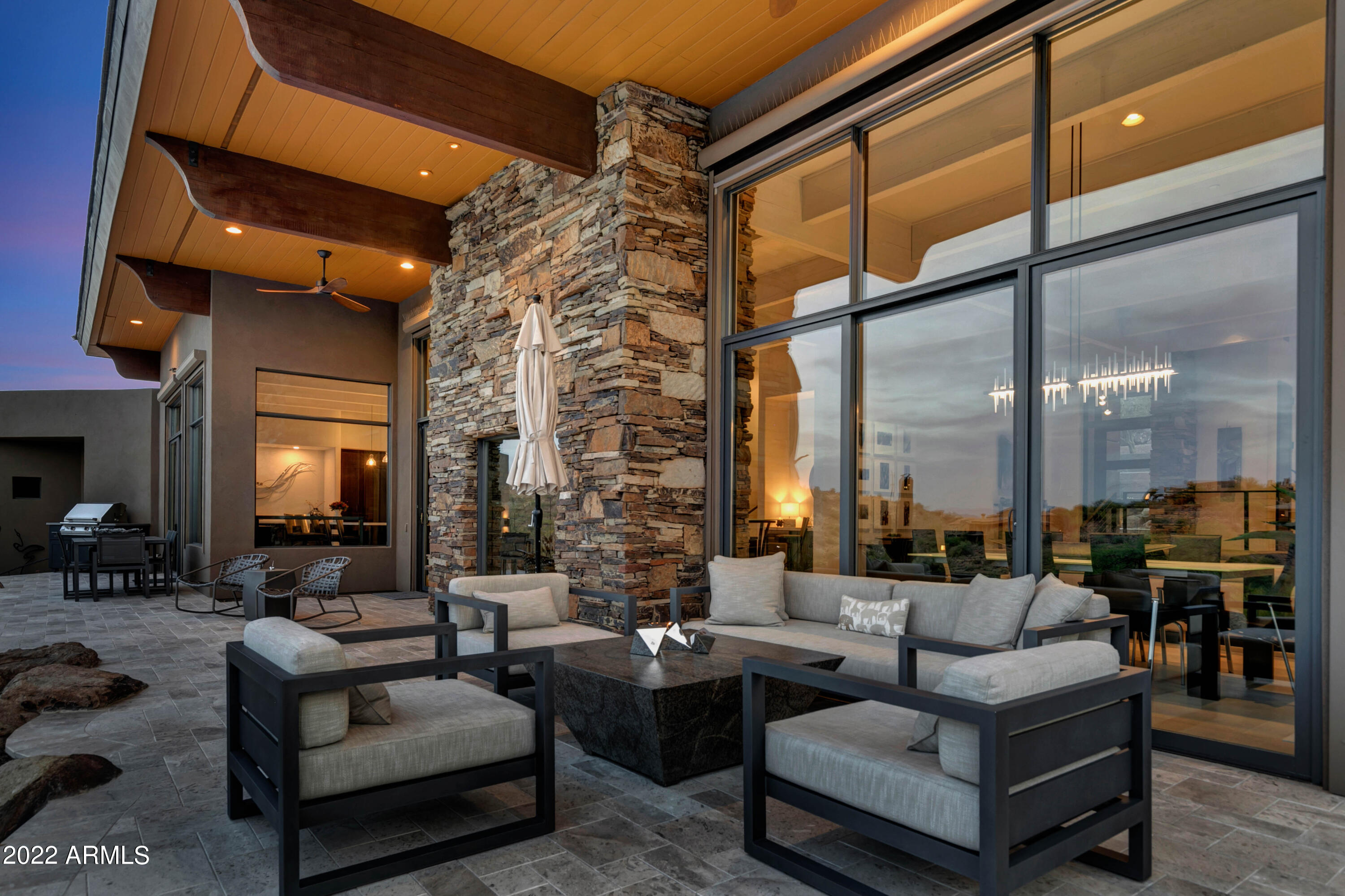 The epitome of FireRock casual elegance, meticulously renovated in 2021!  Features 4-Peaks, Mazatzal and Superstition Mtn views, two fairways and a lake!  Contemporary living space of expansive 14' beamed ceilings, a massive 2-way stone fireplace and floor to ceiling windows to enjoy the views & morning sun, plus a billiards area & bar...a nurturing environment for two or party house for a crowd!  The den is large enough to be a stand-alone theater and the kitchen is award-worthy, with 10' Quartz island, custom Infiniti Design cabinetry, black stainless appliances and views of patios, golf and fun. The perfectly updated Primary Suite, 2 fully suited guest bedrooms and separate casita make this a favorite of family & guests; negative edge pool & two hot tubs provide the ultimate staycation!