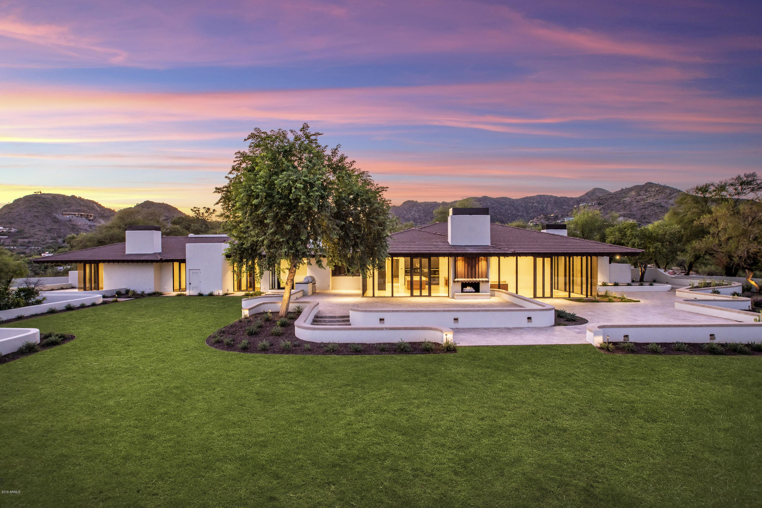Tucked away on one of the most prime Paradise Valley locations, sits a completely remodeled estate so special, that it was once hand-picked for its panoramic views & solitude. Enter through the private gates & be mystified by 2.05 acres of lush grounds perfectly mixed with the tranquility of the Sonoran Desert. Frank Lloyd Wright architectural influence, a flexible floor plan with high ceilings & commercial grade doors & windows that frame the surrounding mountains as if they were pictures on the walls. An opulent master suite with his & her closets, a home gym, in-door sauna & steam room. The privately walled grounds are the perfect entertaining setting with endless views of Camelback & Mummy Mountains. Concrete roof with copper accents, new carrier HVAC units, new water heaters, new water lines, new electrical wiring & new low voltage wiring for a smart home.  This home is a true masterpiece of modern craftsmanship and design.