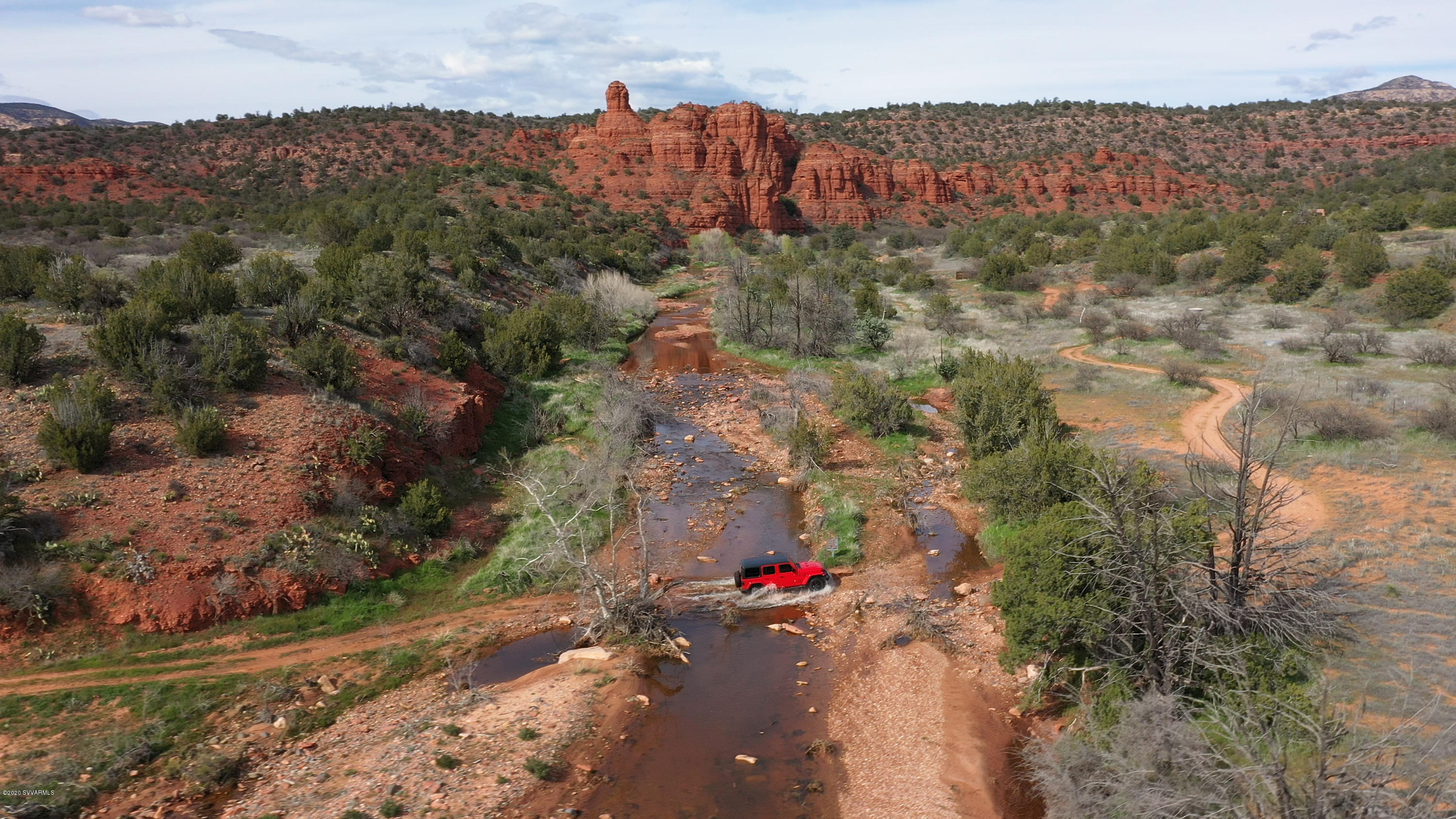 El Rojo Grande, complete privacy...a place to get away from it all! Seize this rare opportunity to purchase El Rojo Grande Ranch, one of the most distinctive privately owned properties located in America's most beautiful city, Sedona, AZ. Just 1.5 miles from Sedona, this private property offers stunning red rock views and much of the land backs to National Forest. Steeped in history, this pristine property offers its next owner extraordinary possibilities. Two options to purchase: 1). Purchase 91 acres (approx.,) of vacant land. Price shall be:  $6,500,000 or 2). Purchase all luxury amenities ; 3 Residences; and 173 acres at El Rojo Grande & Purchase Price shall be: $15,250,000. Videos available in MLS photos & 35 page brochure available upon request. 36 - PAGE BROCHURE AVAILABLE TO SEND ELECTRONICALLY.

VIDEOS FOR PROPERTY: 
1). PURCHASE 91 ACRES ONLY:  https://vimeo.com/403058833  
2). PURCHASE ALL 173 ACRES:  https://youtu.be/NcnlD5OfiTA

THREE OPTIONS TO PURCHASE EL ROJO GRANDE:

OPTION 1
Price Shall Be:  $6,500,000 [Vacant Land Only].
Purchase 90 acres (approx.,) of vacant land. 
Address:  0000 El Rojo Grande Ranch, Sedona, Arizona, 86336
Parcels:  408-29-001F

OPTION 2
Price Shall Be:  $9,950,000 
Purchase 80+ acres (approx.) with three (3) homes, state-of-the-art equestrian facilities, 2.5-acre park, and additional amenities.
Address: 00 El Rojo Grande Ranch, Sedona, Arizona, 86336
Parcels: 408-29-001J; 408-29-001H; 408-29-276A; And A Portion Of Parcel 408-29-001F

OPTION 3
Price Shall Be:   $15,250,000* 
Purchase All Amenities ; Residences; And The Entire 173 acres at El Rojo Grande Ranch
Address:  00 El Rojo Grande Ranch, Sedona, Arizona, 86336 AND                0000 El Rojo Grande Ranch, Sedona, Arizona, 86336
Parcels:  408-29-001J; 408-29-001H; 408-29-276A; 408-29-001F
 
* This premier property is a world-class get-away totaling 173-acres of land, three (3) residential homes, two-and-a-half (2.5) acre park, a state-of-the-art equestrian center, nestled against national forest with red rock views. A brilliant visionary may transform this exceptional property into a world-class health & wellness resort; a self-sustaining family compound; a Fortune 500 corporate retreat; or state-of-the-art equestrian center. A myriad of possibilities  await your concept to re-create extraordinary living. 

* The 6,600 square foot main residence features Contemporary Southwestern style, surrounding patios and terraces, a refreshing lap pool, spa, and fitness room amply designed to take full advantage of the spectacular red rock views. Included are a fully appointed 1,300 SqFt guest house and 1,600 SqFt caretakers house, providing approximately 9,500 square feet of  interior living space. The equestrian facilities are made up of State-of-the-art equestrian center with multiple barns, tack rooms, locker rooms, three equestrian arenas; equine veterinary clinic; and private cantina & bar. The equestrian center is fully appointed to meet the needs of the most demanding riders or their horses. El Rojo Grande provides flexibility for any owner. Of the 173 acres, approximately 159 acres are untouched land and could potentially be developed as a low-density residential community, world-class luxury health resort, a corporate retreat, or family compound. Zoned residential, approval for re-zoning through Yavapai County may be required. 

SUPPLEMENTAL REMARKS FOR 0 EL ROJO GRANDE RANCH LISTED AT: $9,950,000

* Acreage: 80-Acres (Approximately)
* Parcels: 408-29-001J; 408-29-001H; A Portion Of 408-29-001F 
* Main Residence: 6,580 SqFt
* Fully Appointed Guest House: 1,300 SqFt (Approximately)
* Caretaker's House: 1,575 SqFt (Approximately)
* Veterinarian Clinic & Cantina & Storage Rooms: 4,700 SqFt Includes Electricity
* Second Stable: 4,700 SqFt (Approximately); Includes Electricity
* Barn + Commercial Laundry: 4,225 SqFt (Approximately); Includes Electric
* Park: 2 Acres; Bandstand For Music Venues; Cement Benches; Barbeque Area + Bathrooms + Red Rock Views
* Well: Produces Approximately 200 Gallons/Minute & 25,000 Gallon Stainless Steel Storage Tank. Extensive Well Report Completed In 2018
* Surveyed & Split In 2020
* Primary Current Use: Single-Family Residential (Re-Zoning Approval Through Yavapai County)
* Number Of Buildings: 7
* Residence Number Of Stories: All Single Level
* Total Building Area: Main Residence and Pool House; Guest Residence; Caretaker's Residence; East Stable; West Stable; Barn; Pump House
* Constructed Approximately: County Permits Taken In 1993
* Asphalt Pavement: Approximately 20,000 SqFt (Aerial Imagery)
* Carport: 3 Cars
* Foundation: Concrete Slab-On Grade
* Structure: Loan-Bearing Concrete Masonry Unit Walls & Perimeter Wood Stud Walls, Interior Wood Posts
* Exterior Facades: Painted Stucco, Painted Brick Veneer
* Roof On Residences: White Membrane
* Roof On Barns/Stables: Metal Roof Decking
* HVAC: Split Systems W/ Exterior Heat Pumps Interior Air Handling Units; Two Evaporative "Swamp" Coolers
* Electrical: Each Building Has Its Own Meter. 600 Amp, 240/120-Volt Service At Each Building
* Plumbing: Copper Supply; Chromed Brass and PVC Waste
* Water Heaters: Gas-Fired (Propane).
* Fire Suppression System: Fully-Protected With Wet-Pipe Sprinkler System
* Fired Water Heaters
* Zoned Residential - Special Use Permit Or Re-Zoning Would Be Conducted By Yavapai County