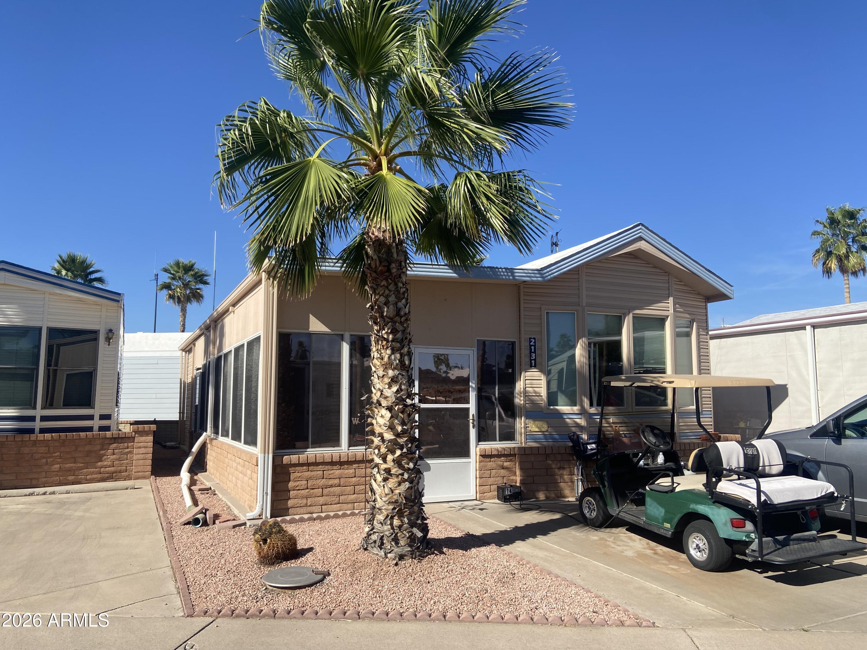 Nicely updated with spacious Arizona room with walk in laundry and storage. Great floor plan, new blinds, solid surface flooring throughout! On a quiet street in the best 55+ golf course community in the east valley! Enjoy the on-site restaurant, therapy pool, lap pool and large community pool with multiple hot tubs, new exercise room, tennis, pickleball, bocce ball, billiards and the list goes on...and on! Dog friendly 55+. Free park tours on request.