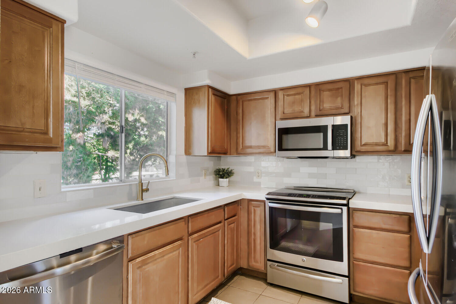 Resort-style living in an upscale lakeside community! Highly sought-after Seabreeze floor plan featuring three true, generously sized bedrooms & a private balcony overlooking a pristine pool. Tucked away from busy streets, this beautifully updated condo offers a peaceful setting with exceptional pool views. The remodeled kitchen shines with new quartz countertops, custom tile backsplash, new faucet, GE Profile induction cooktop, microwave, dishwasher, & stainless steel Samsung refrigerator. Additional upgrades include luxury vinyl plank flooring, custom paint, a beautifully remodeled primary shower (2026), and a new roof on the building (2025). The resort-style amenities of this gated community, include 3 pools, hot tubs, pickleball courts, a fitness center & a clubhouse. Ideally located with convenient access to Loop 202, US 101, Chandler Fashion Center, shopping, dining, and everyday conveniences. Stroll to lakefront restaurants and a nearby grocery store. HOA amenities provide the perfect blend of recreation, convenience, and low-maintenance living.