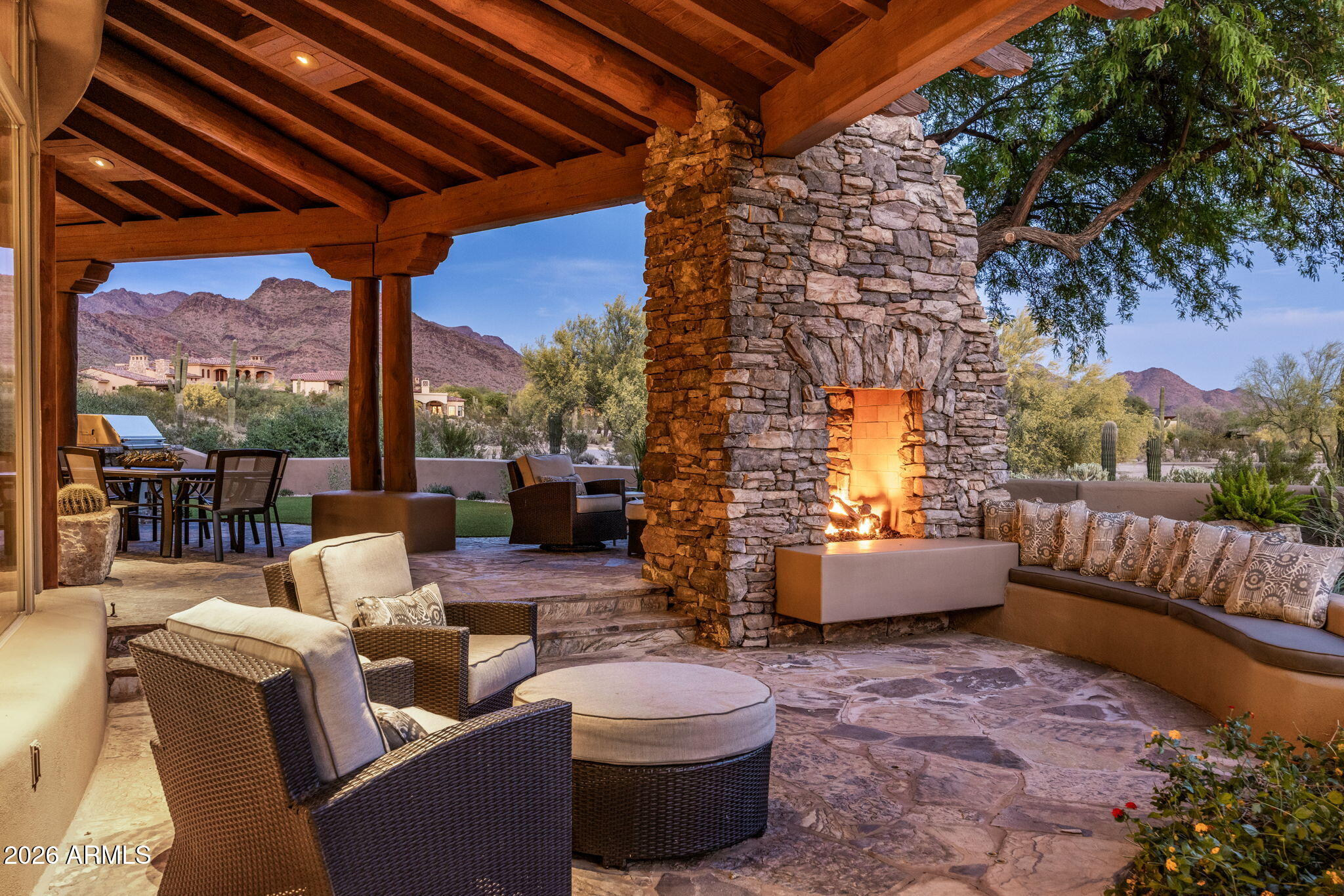 Situated on a cul-de-sac lot overlooking the 4th hole of The Country Club at DC Ranch golf course, this custom home is a stunning blend of design, comfort, and desert harmony. Designed by Bing Hu of H&S International, the distinctive architecture allows the beauty of the Sonoran Desert landscape to be enjoyed from both outside and inside the home. The light-filled 7,178 sq ft floor plan creates a sense of openness and flow, and the home has been tastefully modernized for today's buyer. Anchored by a 2-way stone fireplace, the large great room offers two separate sitting areas, making it ideal for entertaining, yet cozy enough for a quiet night at home. The gourmet kitchen boasts luxury stainless steel appliances including a gas range with double ovens and two additional wall ovens, Sub-Zero refrigerator, a walk-in pantry, and a generous breakfast nook offering dramatic views of the McDowell's. The residence has 5 ensuite bedrooms - 4 bedrooms in the main home and a detached casita, a perfect retreat for guests. An exercise room with a separate exterior entrance, an office, and a generous bonus/flex room with wet bar complete the interior. The outdoor living spaces were crafted for the ultimate Arizona lifestyle. The heated pool and spa, expansive covered patios, two-way fireplace, multiple seating areas, a built-in barbeque, artificial turf-lawn, and low-maintenance landscaping are complemented by picturesque mountain, desert, and golf course views. In addition, the spacious balcony provides panoramic breathtaking vistas, including city lights and Camelback Mountain views. With its prime location within the guard gated Country Club neighborhood of DC Ranch, this classic residence offers a lifestyle of upscale amenities and convenience. The community offers 50 miles of manicured paths and trails, 47 community pocket parks, and the 15,000 sq ft Desert Camp Community Center with a state-of-the-art fitness center, lap pool, kids' splash pool, tennis and pickleball courts, basketball court, playground, grassy play area, and resident gathering spaces. DC Ranch is located adjacent to the McDowell Sonoran Preserve and just 5 minutes north of the 101 Freeway in North Scottsdale. The property is also conveniently located within a mile's walking distance to Market Street's retail shops and restaurants.