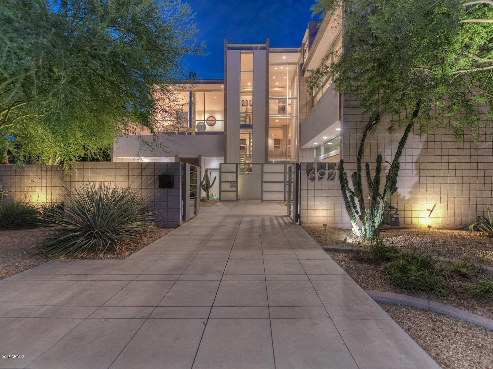 Visually stunning, architecturally sophisticated, meticulously crafted, one of a kind luxury urban living experience in the heart of Old Town Scottsdale. Rare chance to own a stand alone 8200sqft mansion in this hotspot for shopping, entertainment, dining & commerce. Spacious, open living areas with dramatic high ceilings, unparalleled ambiance & uninterrupted comfort. Enter the 36ft tall floor to ceiling glass foyer and experience the ultra-modern steel & concrete construction. Distinctive features abound with a chef's PoggenPohl kitchen, 4 fireplaces, elevator, media room, waterfall-jetted bath, 13 head steam shower, control automation A/V system, gym, 22 motorized shades, garage & parking. Zoned mixed-use residential and/or commercial per Old Town Scottsdale's unique live/work zoning