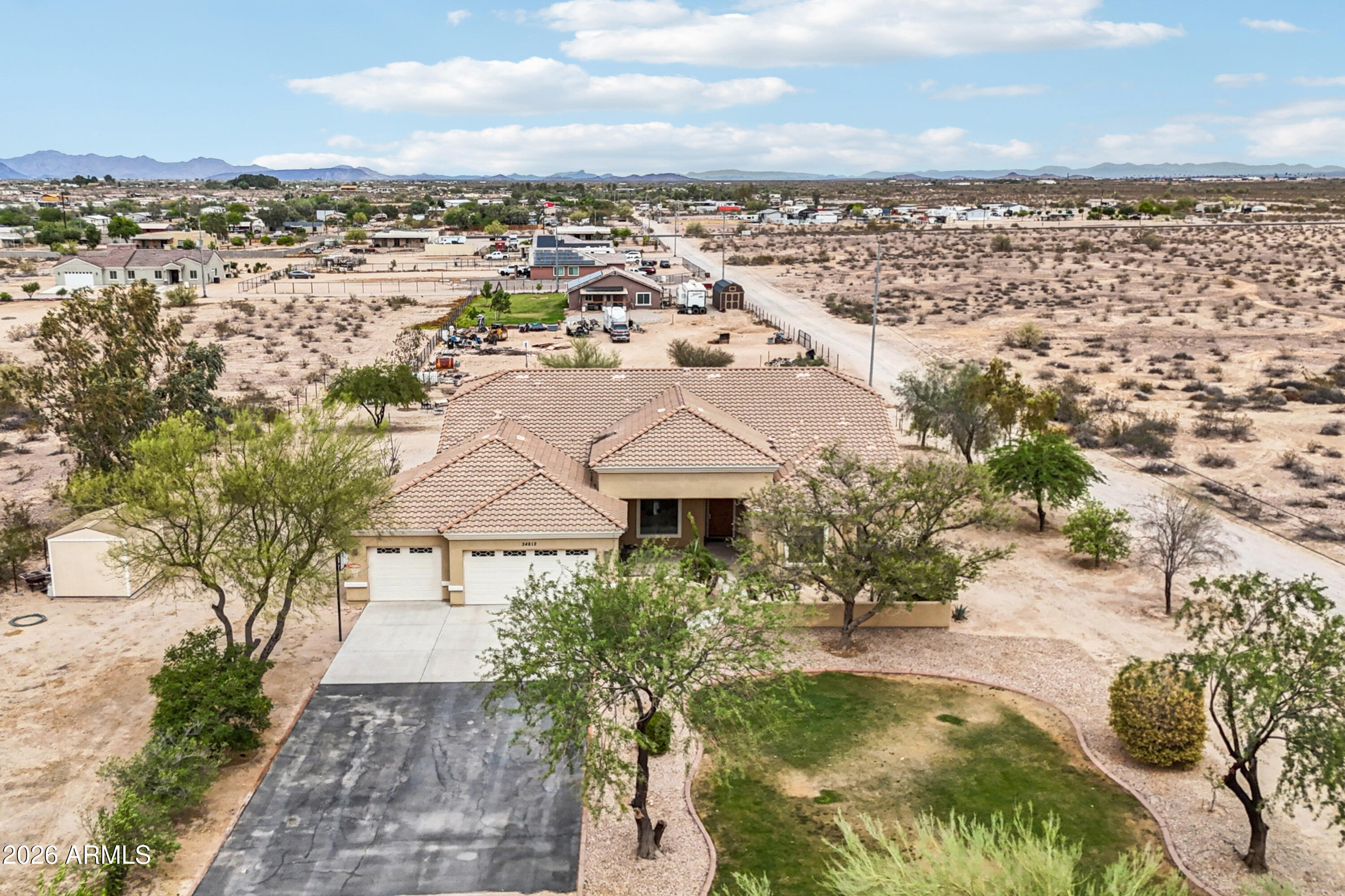 Welcome to this stunning custom home on over 1.4 acres with a private well and no water bill, offering beautiful mountain views and the space, privacy, and flexibility of rural living in Tonopah, Arizona!

This 4 bedroom, 3 bathroom single-level residence offers 3,435 square feet of thoughtfully designed living space with vaulted and 9+ flat ceilings, tile flooring, and an open-concept layout that creates a bright and inviting atmosphere throughout.

The kitchen is a true centerpiece, designed for both everyday functionality and entertaining, featuring granite countertops, rich alder wood cabinetry, a Sub-Zero refrigerator, Wolf appliances, double ovens, electric cooktop, a large center island, breakfast bar, and an oversized walk-in pantry. The layout flows seamlessly into multiple dining and living areas, offering flexibility for gatherings, hosting, or relaxed daily living.

The split primary suite provides a private retreat with coffered ceilings, a dedicated sitting area, and a spacious spa-style bathroom complete with a stone walk-in shower, soaking tub, double vanity, private toilet room, and an expansive walk-in closet.

Secondary bedrooms are generously sized, each with walk-in closets, and offer versatility for guests, home office space, or additional living needs.

Additional features include two AC units, a central vacuum system, dual-pane windows, reverse osmosis, and no interior steps, enhancing both comfort and efficiency throughout the home.

Outdoor living is equally impressive, with covered patios, extended seating areas, and a blend of mature landscaping including grass, irrigation systems, and natural desert elements that complement the surrounding environment. 

The expansive lot provides ample room for horses, RV parking, recreational vehicles, and additional storage, while the 3-car garage, slab parking, and multiple vehicle access points add everyday convenience.

Set in a peaceful rural location with wide open space and scenic surroundings, this property offers a rare combination of upgraded features, usable land, and long-term value, all while maintaining access to nearby Buckeye and the greater Phoenix area.
