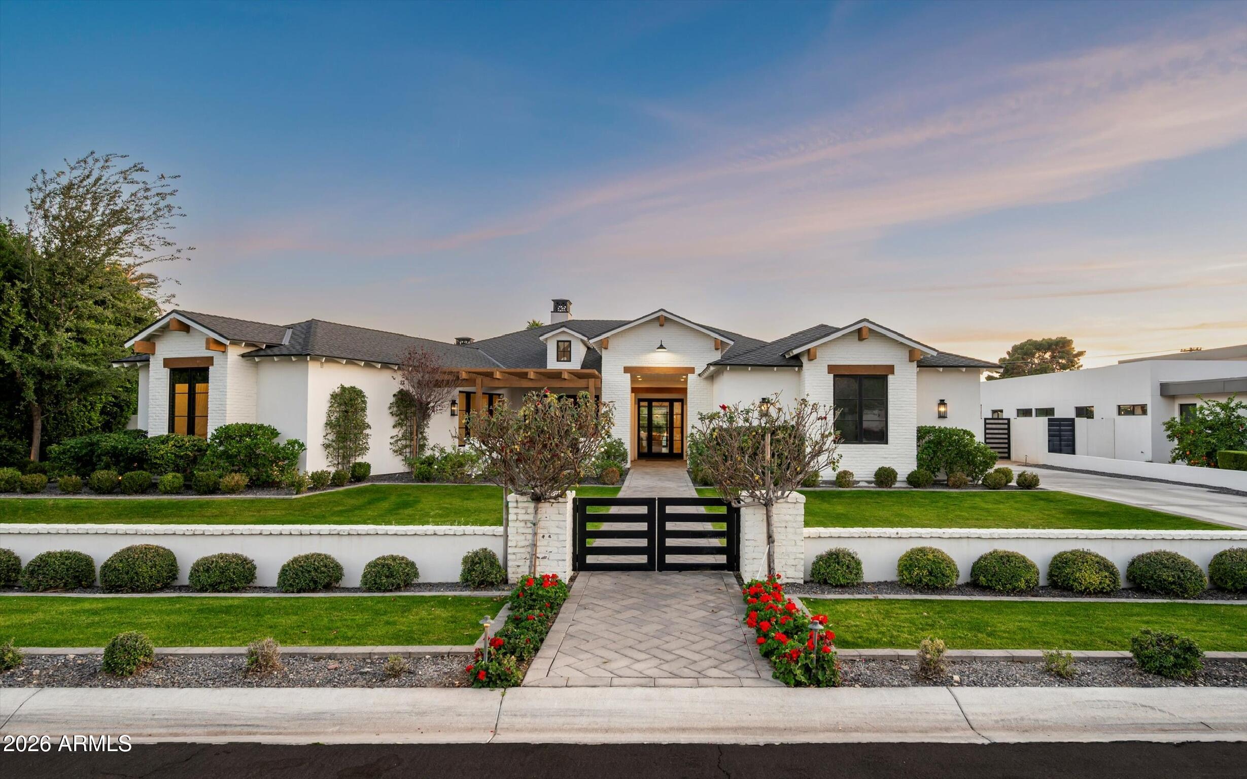 Welcome to this exceptional Arcadia property offering 4 bedrooms, 4.5 bathrooms, two versatile flex spaces, and a dedicated office, perfect for today's work-from-home lifestyle. Situated on a generous .64-acre lot,  this home boasts breathtaking Camelback Mountain views, multiple patios, and lush landscaping surrounding an expansive backyard with endless potential for entertaining, play, or future enhancements. The spacious 4-car garage provides ample room for vehicles, storage, and toys. Thoughtfully designed with flexible living areas, abundant natural light, and seamless indoor-outdoor flow, this property blends comfort, functionality, and iconic Arizona scenery in one of Arcadia's most desirable locations.
