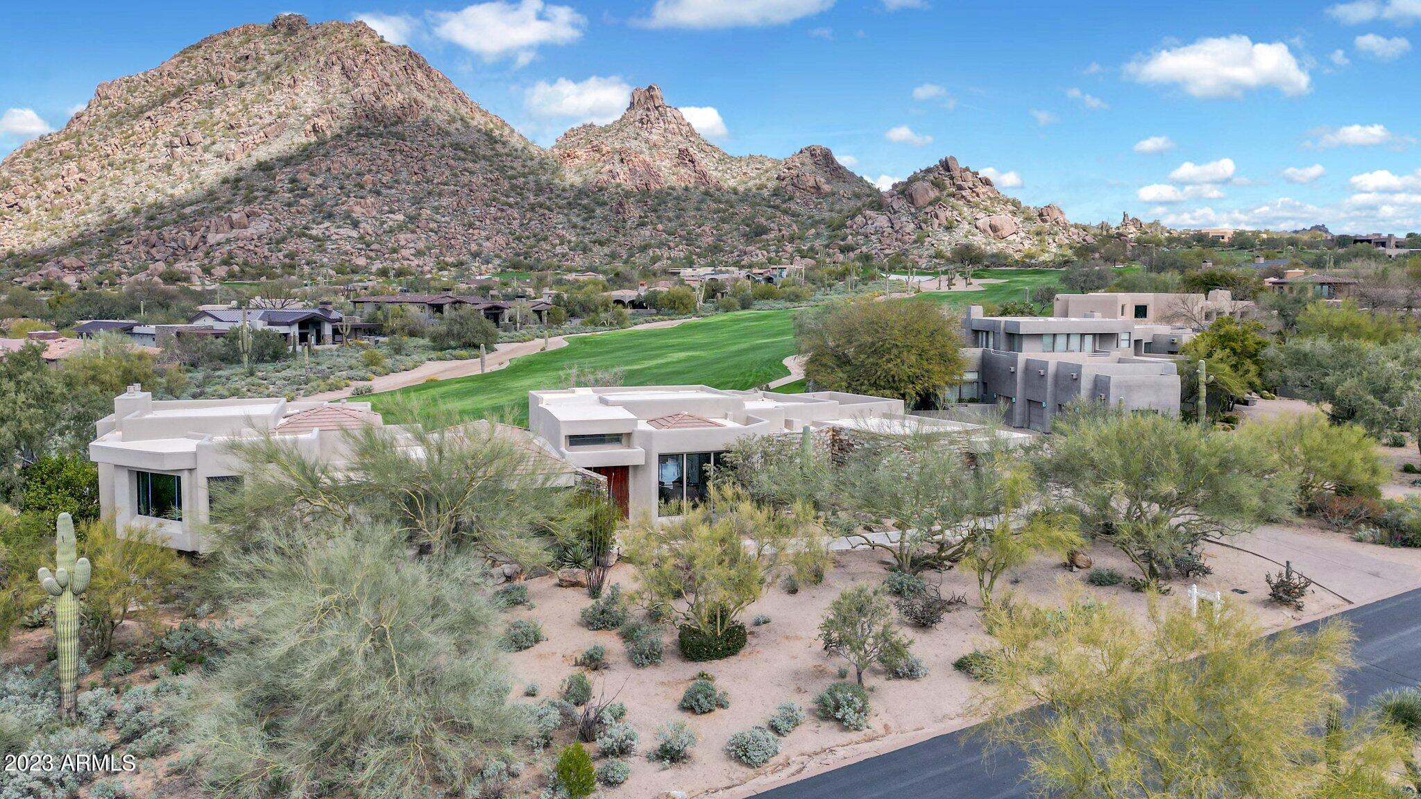 It doesn't get any better than this! Having undergone a complete transformation in 2022, this home is immaculate & ideally situated along the 9th fairway with Pinnacle Peak centerstage as the backdrop. Upon entry through the custom front door, you're awed by the views. Gorgeous European Oak wood flooring, a 12' multi-pocket slider, Metallica black tile wrapped to the ceiling around the linear gas fireplace all are sure to excite. The newly designed kitchen showcases custom cabinetry & Arabescato Como quartz counters w/ a waterfall island & a professional series Sub Zero & Wolf appliance package. A newly expanded breakfast nook now offers picturesque windows, and an ample-sized butler's pantry has 2 beverage fridges. Down the art gallery hall, you'll find 2 offices (1 that can be a bedroom by converting exterior closet inside room), a beautiful bath & a dedicated theater w/ 7 stadium seating chairs (included). 
Upstairs is the primary suite w/ stunning fireplace adorned in Shara Noir tile. The primary bath boasts Grigio Salt cabinets, Talia Grey quartz tops, a splendid shower & oval tub w/ Luxe Gold Brizo finishes as well as dual closets w/ custom built-ins and a 2nd W/D for convenience. Downstairs are the 2 oversized guest rooms w/ ensuite baths & superb finishes along with direct courtyard access with tons of natural light. 
The backyard has it all w/ a newly pebbled & waterline tiled pool & spa (both heated) along w/ Pentair remote access. The BBQ station and lounge area are the perfect spot to enjoy the sensational scenery. 
A Control4 system, Lutron lighting & automated shades throughout puts everything at your fingertips. Mechanicals haven't been overlooked as the 4 Trane HVAC units, 2 tankless water heaters, water softener & pool equipment are all new. Plus, new garage doors, openers, and epoxy flooring. 
Desert Highlands boasts world class amenities, including a Jack Nicklaus championship golf course, 18-hole putting course, an award-winning clubhouse featuring ''Jack's'' gastropub, state of the art fitness center, Highlands Racquet Club with grass, clay & pickleball courts. Scottsdale living at its finest!
