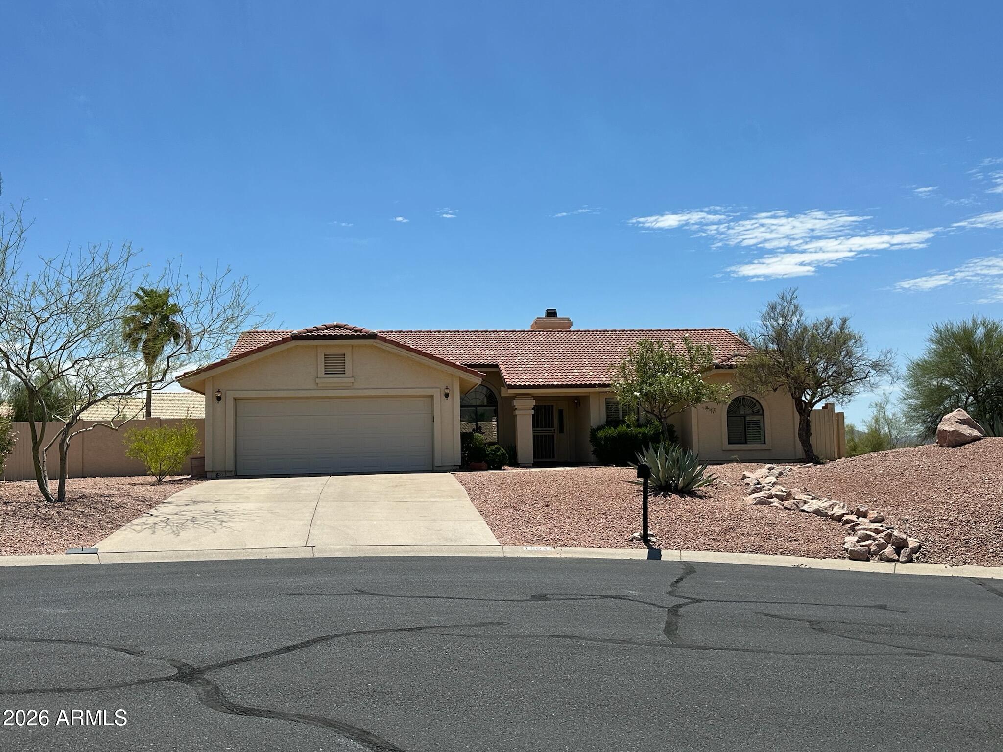 Tucked at the top of a quiet cul-de-sac, this adorable custom home offers the kind of setting that's hard to find -- elevated, private, and surrounded by some of Fountain Hills' most iconic scenery. Red Mountain views grace the back patio, while the McDowell Mountains frame the view out front. There's truly no wrong direction to look.
Inside, the home feels open and light-filled thanks to soaring vaulted ceilings and an abundance of windows that bring the outdoors in. Saltillo tile and neutral carpet flow throughout, complemented by a cozy fireplace that anchors the living space with warmth and character. Best of all -- no interior steps, making this a rare single-level custom home that works beautifully for all lifestyles.
The kitchen has been thoughtfully updated with ... granite countertops, and refurbished cabinetry. 
Step outside and discover your private retreat: a sparkling pool, a putting green for the golf enthusiast, and lush mature landscaping that creates the perfect backdrop for entertaining or simply enjoying a quiet Arizona evening.
Sitting on nearly half an acre in one of Fountain Hills' most beloved neighborhoods, this home delivers charm, comfort, and great views in one terrific package.
