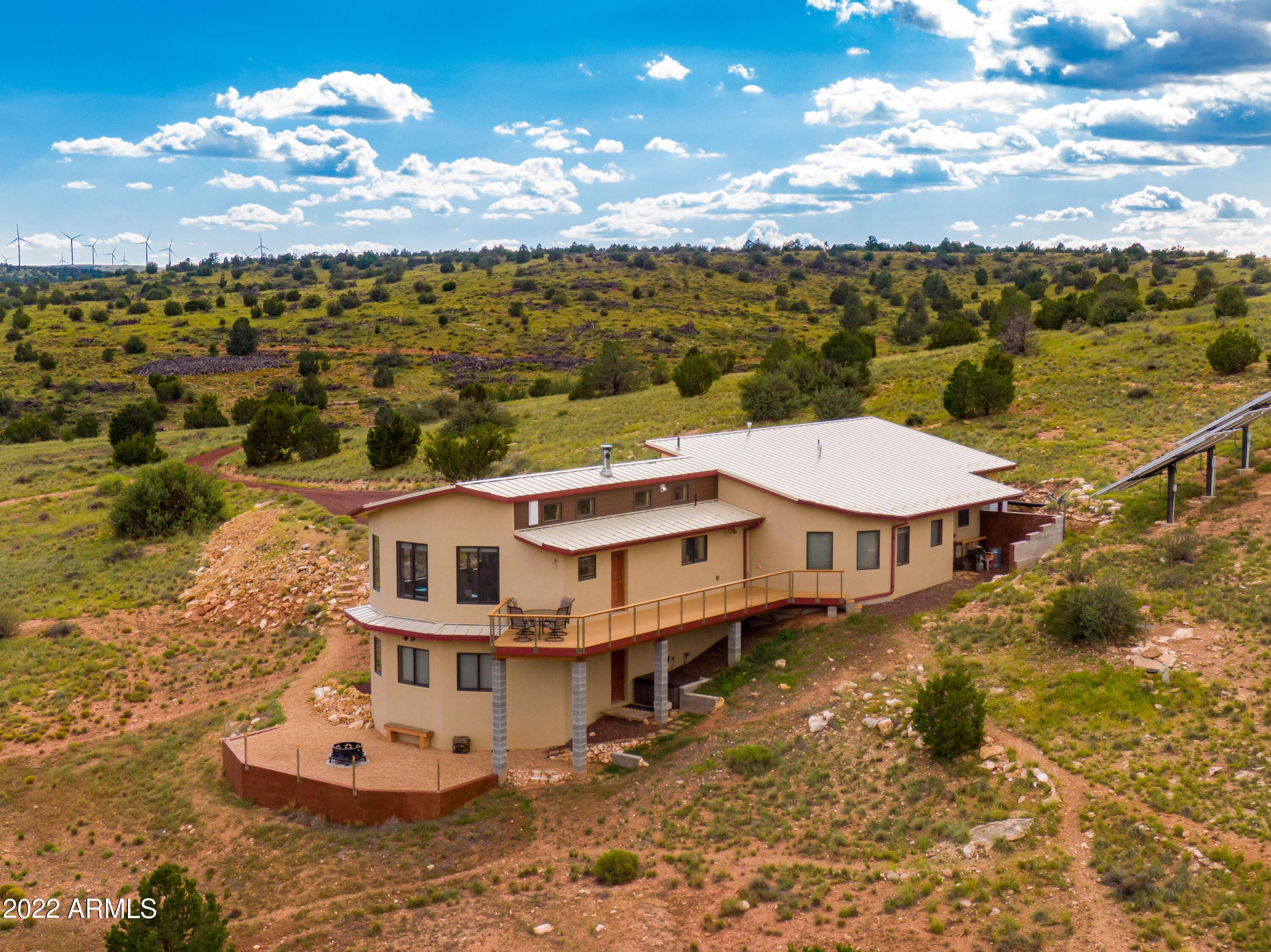 VIRTUAL TOUR!
facebook/JFullerRealEstate/live_videos
Motivated Seller!! Welcome to Deadwood Ranch! Experience nightly dark skies in solitude while still enjoying the comfort and luxury that city living provides. Experience sustainable OFF-GRID living and all four seasons in this stunning, custom built home. The kitchen and living room combo provides ample space to host your guests. Stretch and explore your 36.03 ACRES. Easily store your pantry overflow in the spacious wine cellar. Experience peace and privacy with your neighbors being miles away. This property is conveniently located 1 hour from the south rim of the Grand Canyon and 1 hour away from the Arizona Snow Bowl Ski Resort. You don't want to miss out on this one of a kind, custom designed beauty. This home was built with such efficiency that the owners have NEVER HAULED WATER FOR THE HOUSE! Current utility costs are less than 500 dollars a year- owners only pay gas and trash. Brand new batteries and 15000 watt inverter for the solar have been installed.
Equip with energy-efficient, 12" thick AAC blocks, solid wood doors, and stamped concrete flooring, this home is the definition of efficiency and sophistication in one beautifully designed package. This home was meticulously designed to take advantage of the natural setting and panoramic views. The guiding principals of this design were resource efficiency, comfort, safety, low maintenance, and self-reliance. Coconino County has awarded the Sustainable Building "Advanced Plus" Award as this home meets or exceeds all of the requirements associated with the Sustainable Building Program.