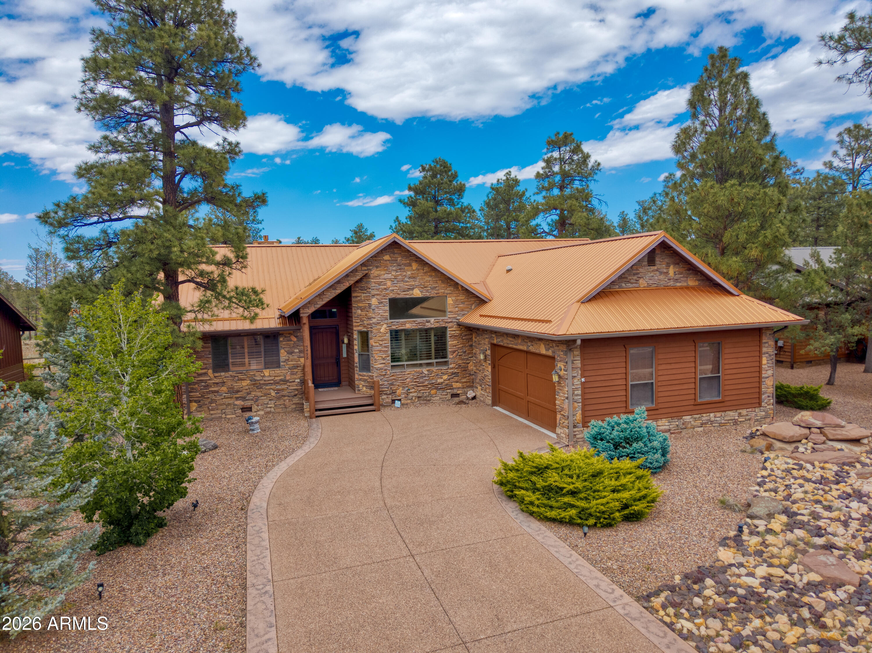Located in the cool white Mountains of Arizona is this impressive, Fully Furnished, 2,510-square-foot 3-bed, Office Den, 2.5-bath rock-siding home, with an unmistakable back-covered deck, offering views of an open, treed forest, a metal roof, and an extended 2-car garage. It is the largest home in one of the most desirable, quiet gated communities, Elk Springs subdivision. This site-built home sits on one of the most prestigious, beautiful lots surrounded by tall pines with a backyard view of an open forest area in the neighborhood. As you walk in through the front door and into the foyer, you will feel instantly at home in this spacious, open-concept, elegant, and dynamic Great Room with vaulted T&G ceilings and a floor-to-ceiling stacked-stone gas fireplace with a beautiful custom wood mantel. The open-concept design flows seamlessly throughout, allowing access to all parts of the home on a luxurious wood plank floor. To the right, you will be amazed by this beautiful, unmistakably functional Chef's kitchen, equipped with a gas range, knotty alder cabinetry, granite countertops, top-of-the-line appliances, and a large pantry, including a separate breakfast area and a study/den, all under a T&G ceiling. Next, a full-size laundry room with cabinets/garage access, a split-level floor plan offering privacy and balance, featuring an oversized primary suite, with access to the large covered back deck, a huge master closet, and a spacious bath complete with a soaker tub, a tiled walk-in shower, with ample space to unwind, a true retreat. Also includes a theater room/study den, plus 2 other spacious bedrooms, one of which also has access to the back-covered deck. The home also includes a central vacuum system, a new water heater, and a small fenced-in dog run in the backyard.
