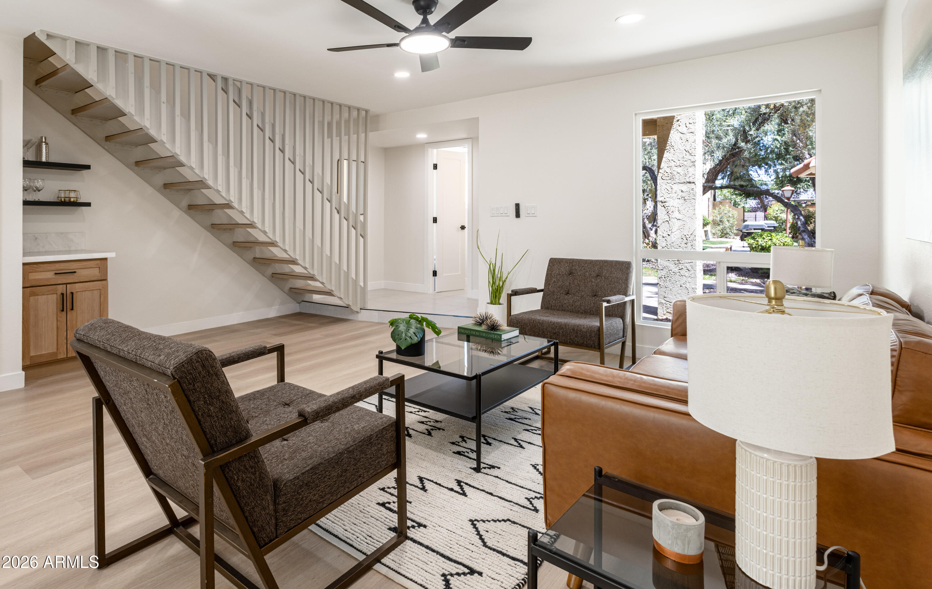 Completely remodeled townhome blending modern luxury with timeless design in the heart of North Central Phoenix. This stunning home features a designer kitchen with white oak soft-close cabinetry, Namib Bianco marble countertops, custom tile backsplash, stainless steel appliances, pantry, and coffee bar with floating shelves. Wide-plank flooring and fresh paint throughout. Upstairs offers two spacious bedrooms, including one with a private balcony. New bathrooms showcase white oak vanities, designer tile, and sleek black fixtures. Enjoy a private rear patio with mature lemon tree plus major upgrades including new windows/sliders, interior doors, tankless water heater, recoated roof, and newer AC (2024). Quiet location overlooking lush green space and community pool. A must see!