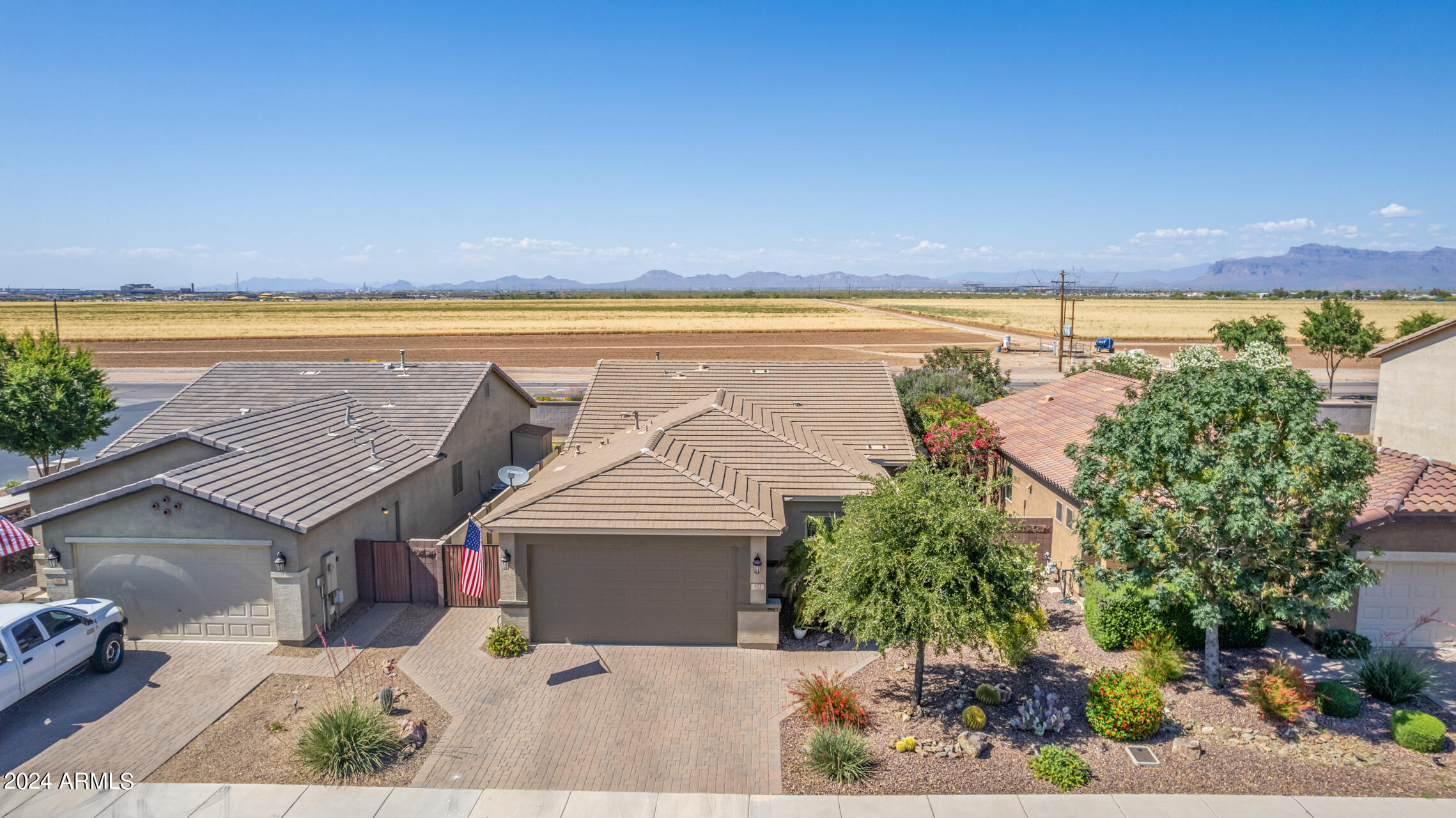 Immaculate Energy Star Fulton home with stunning Superstition Mountain views located in the highly desirable master-planned community of Ironwood Crossing. This meticulously maintained, single-owner home features approximately 1,790 square feet with a thoughtfully designed split floor plan offering 3 bedrooms, a private office/den, and 2 bathrooms.

Designed for comfort  living, the open great room layout is bright and inviting with large neutral tile flooring, abundant natural light, custom blinds, and ceiling fans throughout. An expansive multi-panel sliding glass door opens to a beautifully covered patio, creating seamless indoor-outdoor living and the perfect space to relax and enjoy the mountain views. The kitchen is ideal for cooking and entertaining with warm staggered maple cabinetry, granite countertops with 3cm edge detail, stainless steel appliances, gas range, pantry, and an oversized island that overlooks the dining nook and great room. The home also includes a reverse osmosis drinking water system and an owned water softener.
The spacious primary suite offers a peaceful retreat with a large walk-in closet, dual vanities, and an upgraded frameless glass walk-in shower. Secondary bedrooms are located on the opposite side of the home, providing privacy and flexibility for family or guests.

Additional upgrades include a 2-car garage with a 4-foot extension, built-in garage cabinets and shelving, garage utility sink, Low-E energy efficient windows, superior insulation with R-19 side walls and R-30 ceiling insulation, and ceiling fan prewires throughout.

The exterior offers excellent curb appeal with a paver driveway and walkway, double and single gates including a double RV gate, landscaped yard with decorative boulders, drip irrigation system, gutters, and exterior paint completed less than two years ago. The home is also conveniently located directly across the street from a park and playground.

Residents of Ironwood Crossing enjoy exceptional resort-style amenities including over 20 tot lots, an 18-hole disc golf course, two community pools including the Ira Fulton Aquatics Center, a splash pad, pickleball courts, bocce ball, sand volleyball, horseshoe pits, lighted basketball courts, a soccer field, and miles of scenic walking paths. The community also hosts popular resident events throughout the year such as Movies at the Park and Pool, Hop Into Spring, and the Pumpkin Harvest Festival.

Conveniently located near Queen Creek Marketplace with easy access to shopping, dining, parks, and Highway 24, this move-in-ready home offers the perfect combination of comfort, upgrades, and community living.
