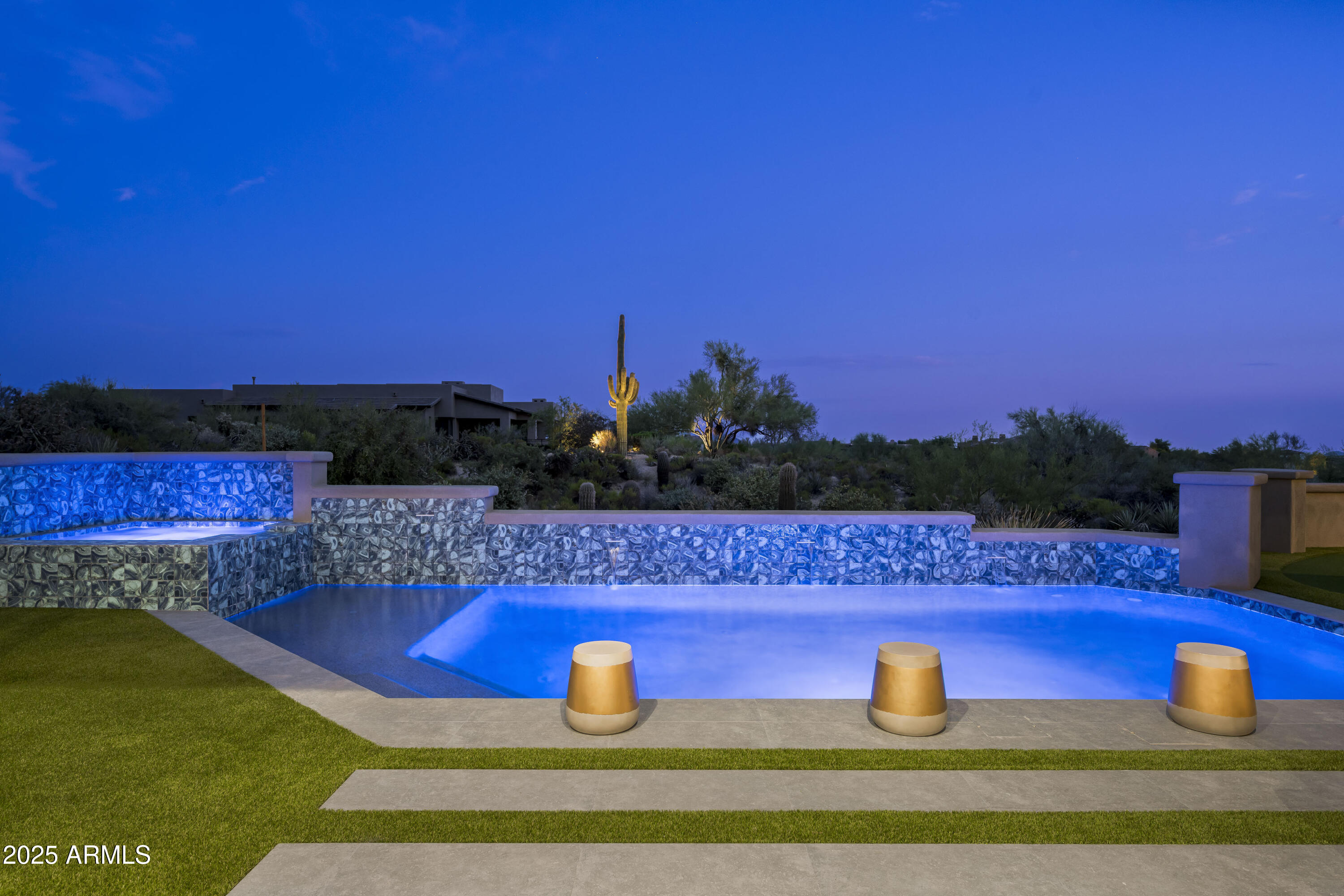 GOLF MEMBERSHIP AVAILABLE for transfer. 
A One-of-a-Kind architectural statement in Desert Mountain. Designed by the renowned Jaque Bethke, this 5,991 sq. ft. masterpiece in the Village of Sunrise at Desert Mountain is a true work of art, where bold design, vibrant style, and impeccable craftsmanship come together in a way that simply cannot be duplicated. Every room in this residence has been expertly curated to exude luxury, creativity, and unparalleled quality. The vision behind this full rebuild was to create a home that isn't just lived in—it's experienced. From custom finishes to architectural details that push the boundaries of design, this home is for those who appreciate one-of-a-kind artistry in a luxury setting. The interiors are an extraordinary blend of vibrant, daring aesthetics and refined sophistication. The open living spaces flow seamlessly, offering both dramatic impact and functional elegance. The primary suite is a retreat like no other, and each additional bedroom is its own individual design statement, ensuring no two spaces feel the same.
Beyond the walls, the meticulously designed backyard mirrors the home's architectural brilliance. A stunning pool, spa, and water feature anchor the outdoor space, while the covered patio with a full outdoor kitchen, lush turf, and a perfectly integrated putting green create an entertainer's dream with an unmistakable presence.
This home is not just about designit also delivers on state-of-the-art technology and modern luxury. A Josh AI smart home system, a vented flex room off the three-car garage, and elevated ceilings in the third bay provide both form and function. Plus, with a Golf Membership available for transfer, this home offers the rare chance to own a truly unparalleled property in one of North Scottsdale's most exclusive communities.
This home is for those who seek something different, something bold, something that sets a new standard for luxury living in Desert Mountain.