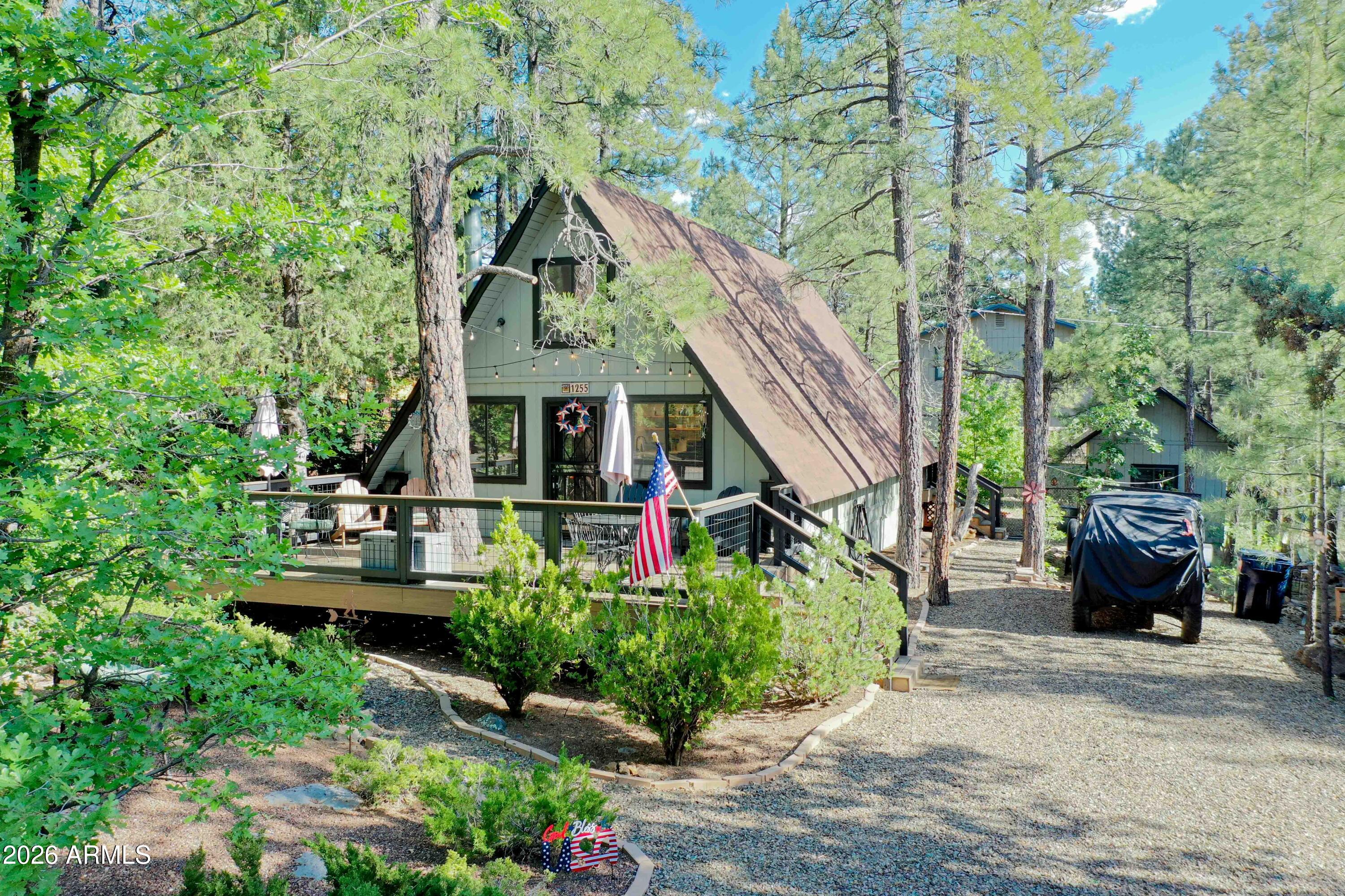 Escape the Phoenix heat and discover this beautifully remodeled A-Frame cabin on famous Animal Hill in Munds Park! This fully furnished mountain retreat features 2 bed, 2 bath, a spacious loft, soaring ceilings, tongue-and-groove wood accents, cozy fireplace, and an open-concept living area. Recent upgrades include new flooring upstairs and downstairs (2024), new water heaters (2024), remodeled kitchen (2025), new front and rear decks (2025), new interior paint (2025), and a remodeled upstairs bathroom (2026). Enjoy a fenced yard, storage shed, and oversized lot surrounded by towering pines. Just 90 minutes from Phoenix and minutes from Pinewood Country Club, Lake O'Dell, hiking, biking, ATV trails, pickleball, dining, and Coconino National Forest. Full-time home, vacation home or invest!
