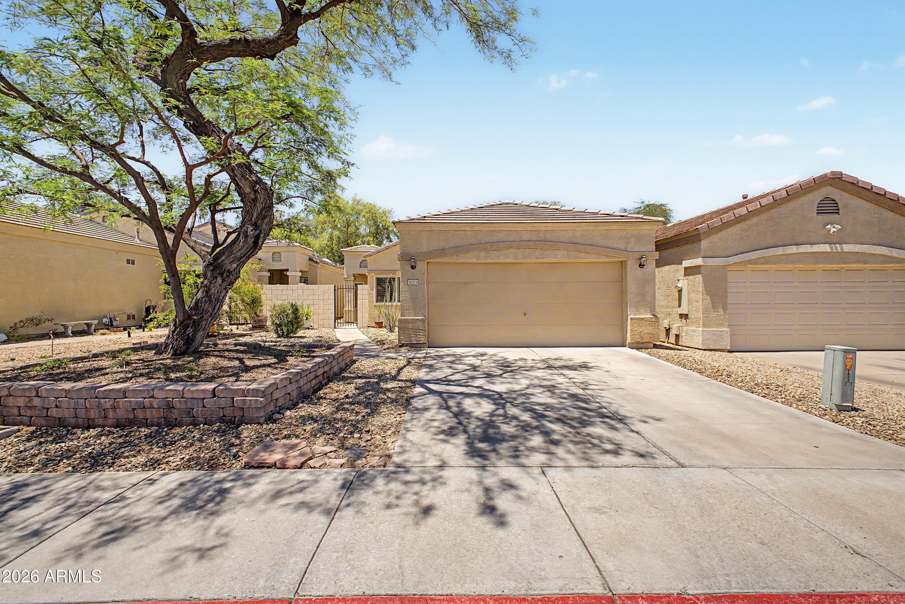 Beautiful 2-bedroom, 2-bathroom home with office in gated Ravenswood Patio Homes located between The Raven and Legacy Golf Courses. This thoughtfully designed home features an open living space with high ceilings and abundant natural light. Freshly painted, Plantation Shutters, wood floors in living spaces and carpet in bedrooms. The spacious primary suite offers private access to the slate covered patio, creating a seamless indoor-outdoor retreat.  Enjoy a charming courtyard entry and the privacy of a small gated community with pool /spa right across the street, great walking paths and lush landscaping.  Ideal for comfortable living and entertaining in a highly desirable location.  Minutes to restaurants, shopping and entertainment downtown, hiking and biking in South Mountain Preserve,