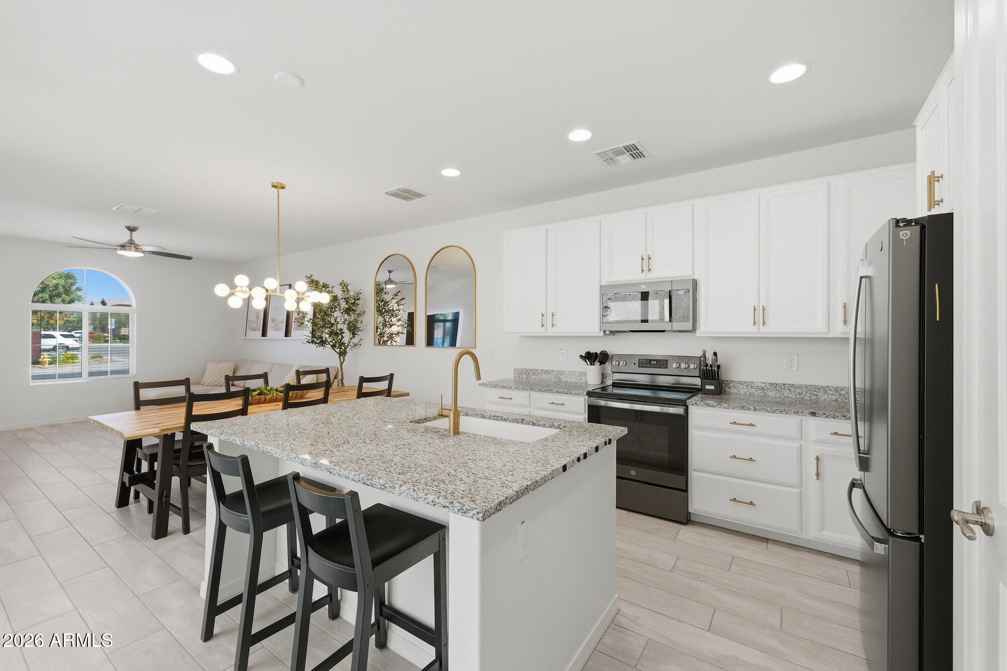 Beautifully upgraded home on a premium lot with extra parking and over $50K in builder upgrades! Perfect for a first-time buyer, vacation home, or multi-generational living with a bedroom and full bath on the main floor. Located in sought-after Cooley Station with 2 pools, basketball courts, bocce ball, and parks. Conveniently near the Loop 202, Phoenix-Mesa Gateway Airport, and Arizona State University Polytechnic Campus. Features include 42'' white cabinets with gold hardware, slate appliances, 9' ceilings, 8' doors, EV outlet, tankless water heater, water softener, Wi-Fi garage, gas stove plumbing, covered patio, and amazing courtyard views from the kitchen.  See documents tab for a detailed list of builder upgrades.