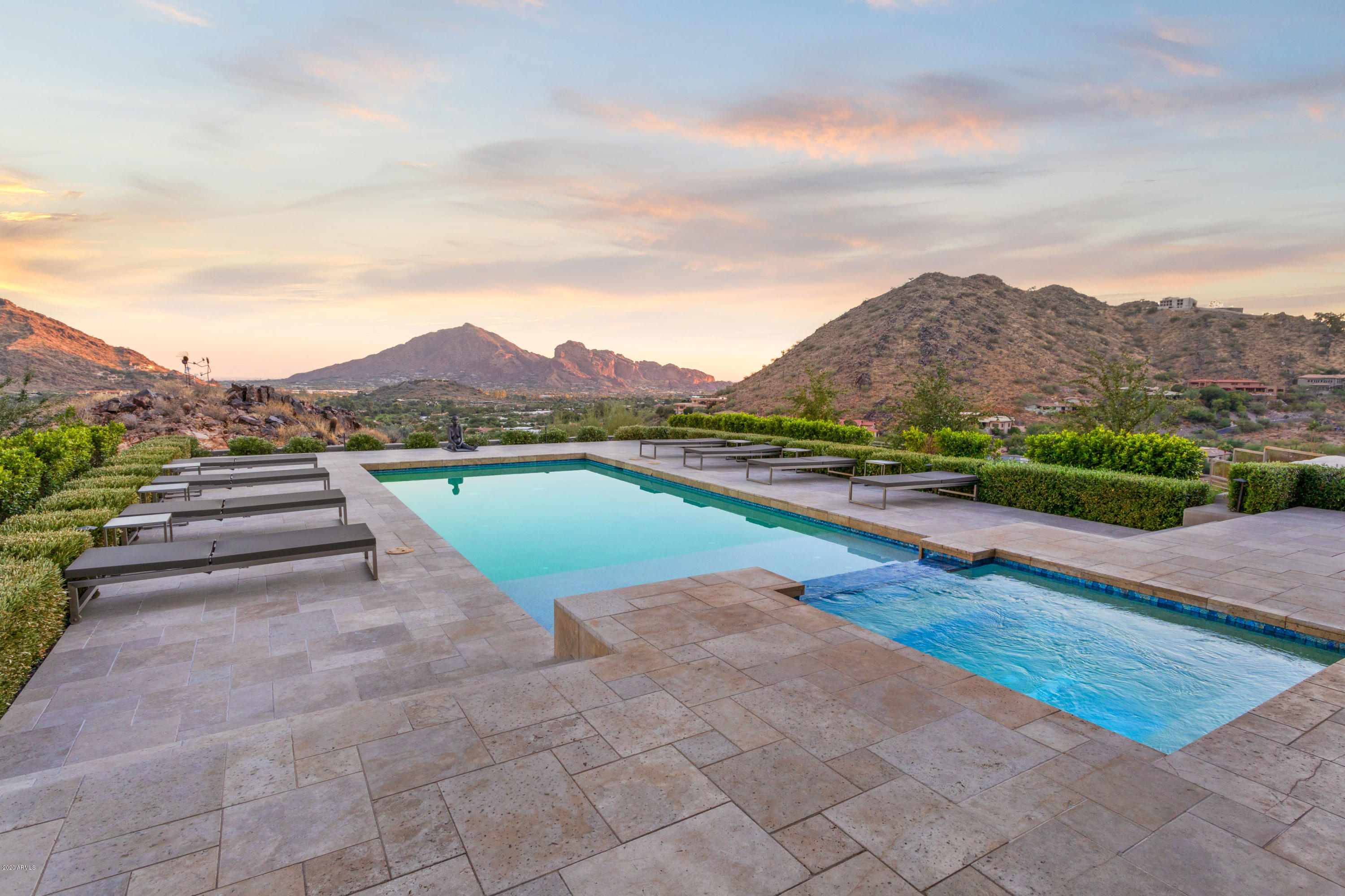 Welcome to the most breathtaking views in all of Paradise Valley! Hillop with unobstructed lines of sight throughout the entire valley, reaching from Camelback Mountain, to the Four Peaks and The McDowells. This stunning gated soft contemporary estate spans over 2 acres and boasting timeless architecture with bright and airy design. Jaw-dropping views from every room, hand plastered walls, high ceilings, custom stone flooring, this home will leave you feeling enchanted. Spacious living spaces with formal living and dining room featuring doors to backyard for seamless indoor-outdoor entertaining. Light and bright kitchen with Viking appliances, Sub-Zero plus two additional refrigerator drawers, multiple farm sinks, spacious butler's pantry and casual eat-in nook. The master suite features a cozy wood burning fireplace, dual walk-in closets and expansive shower with private courtyard. Library/loft, reading room, tv room and home gym allows for plenty of relaxation opportunities. Magnificent landscaping with resort inspired pool and jacuzzi, covered bocci ball court, artificial turf, water features and plenty of covered patio space. Don't miss your chance at this once in a lifetime estate.