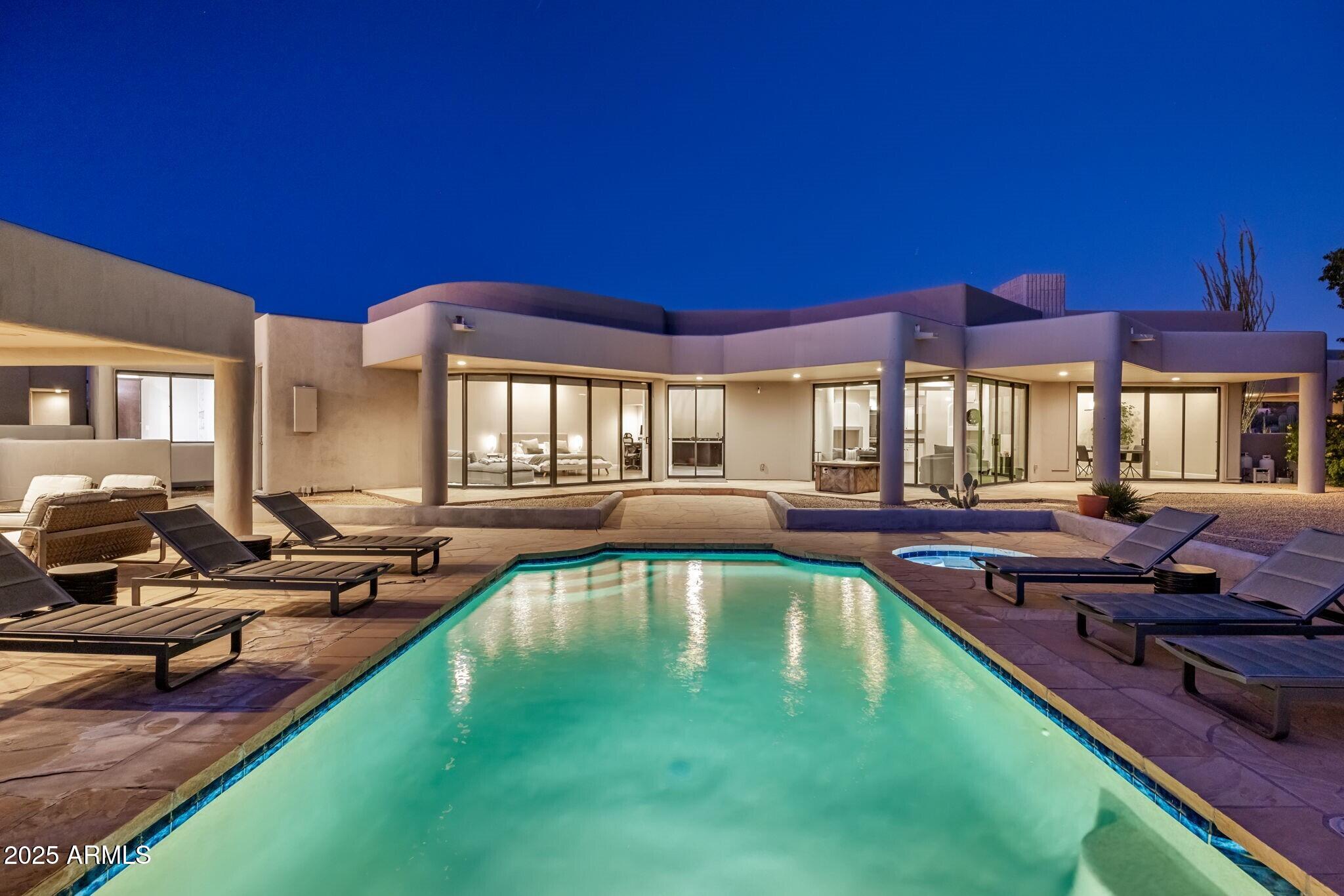 Stunning single-level estate with 4 bedrooms, 4.5 baths, which includes a full guest house, and captivating views—this is a rare, special property. Tucked within a serene enclave, this residence combines effortless living with exceptional privacy. The open, light-filled layout flows seamlessly to multiple outdoor spaces designed for year-round enjoyment. The main home features generous ensuite bedrooms, refined finishes, and a spacious great room anchored by large picture windows that frame the surrounding views. The gourmet kitchen offers abundant prep space and a functional layout ideal for both everyday living and entertaining. A separate guest house provides the perfect retreat for visitors, extended family, or a private office/studio setup. Outdoors, enjoy sun-soaked patios...more and covered lounging areas, and room to take in the views in every direction. All on one level with a 3-car garage, thoughtful design, and undeniable charmthis property stands out as a truly unique opportunity in North Scottsdale.