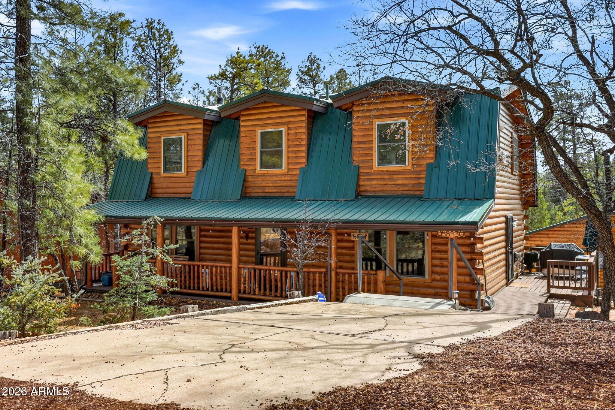 $64,000 BELOW APPRAISAL Nestled on a quiet cul-de-sac on a one-third acre lot, this charming log-sided cabin offers true lakeside warmth and privacy. A highly successful vacation rental, it features a covered porch with swing, multiple outdoor sitting and dining areas, and a hot tub. Inside, enjoy cozy country charm with warm wood accents, exposed beams, and a spacious family room with two thermostat-controlled natural gas fireplaces. The main floor includes a powder room and an office/den that can serve as a 5th bedroom. Large pine trees surround the property, a two-plus car garage & matching storage shed, both with durable metal roofs. Fully furnished and ready to enjoy. $50,000 year vacation income home.