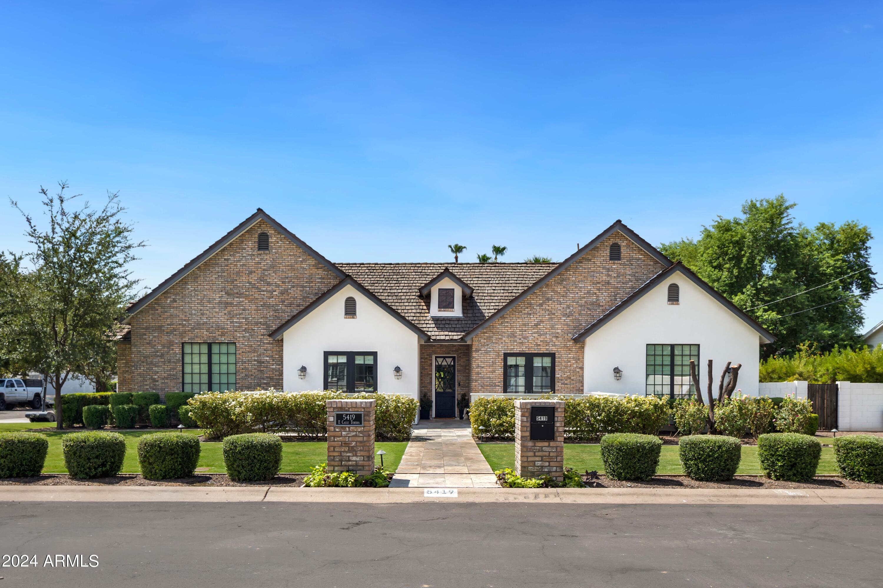 Welcome to this meticulously crafted newer construction, embodying the true spirit of Arcadia living. Nestled in a private enclave of the highly sought-after Arcadia neighborhood, this home boasts stunning curb appeal. The well-designed split floor plan offers 4 bedrooms, 4.5 baths, plus an office and a teen room, ensuring a layout that's both functional and ideal for modern living. French doors throughout the home are perfectly positioned to frame picturesque backyard views from every living space. The kitchen is a chef's dream, featuring a spacious island, Thermador appliances, and ample counter space for effortless entertaining. The primary suite is a true retreat, offering serene backyard views, a cozy private sitting area with a fireplace, and a generous closet. All guest bedrooms are spacious and ensuite, providing comfort and privacy. Step outside into your own private oasis, complete with low-maintenance artificial turf, multiple seating areas, an outdoor fireplace, and a beautiful pool - perfect for enjoying the best of Arizona living.