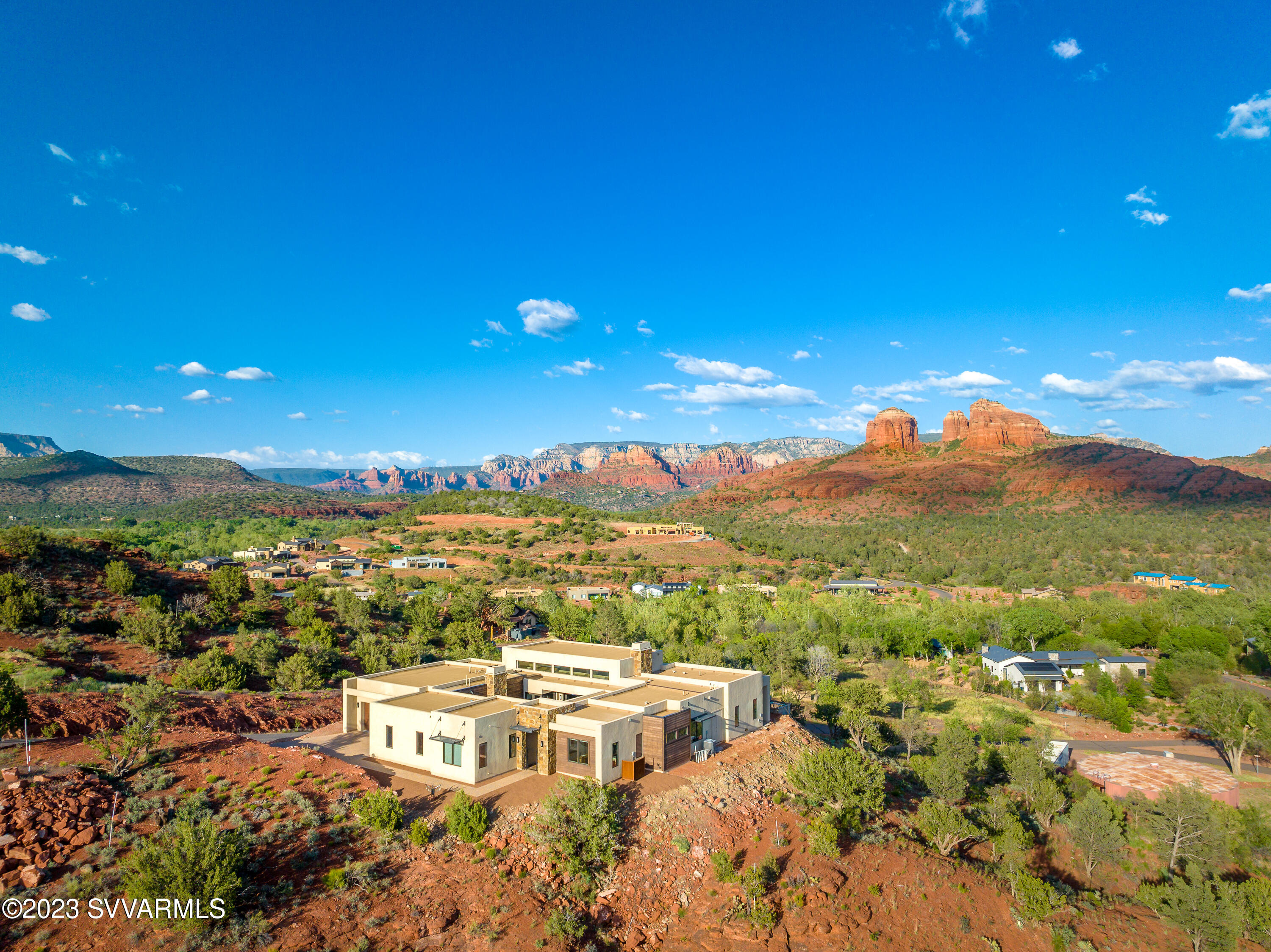 Elevated living! Experience jaw dropping, panoramic RR views from nearly every window as well as enchanting creek views from this stunning contemporary home, situated on THE premier lot in Sedona Ranch on Oak Creek. Fabulous layout - this home includes:  3357 Sq. Ft. ,4 BR, 4.5 BA, + glass den, private courtyard w/FP, 4 car garage situated on 2.18 acres.  Features include: high ceilings, hardwood floors, wide plank tile, contemporary fixtures, paver driveway, courtyard & patio, exterior stone accents, sliding glass doors. Sedona Ranch on Oak Creek offers the highly coveted benefit of connecting W. Sedona & the Village of Oak Creek through special gate access. See  supp. for more info & amenities list This beautiful home is situated on THE premier lot in Sedona Ranch on Oak Creek - the lot next door just sold for $1.1 mil.

Per Builder - Dorn Homes-- This home is Energy Star Certified - Buyer to Verify.

1460 Square Foot --4 Car Garage

Seller created an extra area for guest parking at the bottom
of the lot. 

Private 739 square foot paver courtyard with fireplace and stunning views!

Kitchen features:
Granite Waterfall Island with breakfast bar
Abundant cabinetry and drawers
Walk-in Pantry
SS Sink
Instant Hot Water & RO 
Appliance Storage 

Luxury stainless appliances:
Wolf 6 Burner Gas Range with oven
GE Wall Oven & Microwave
Asko Dishwasher

Great Room Features:
Incredible, all-encompassing views 
Sliding Glass Doors accessing Patio and Courtyard
(with motorized blinds)
Soaring Ceilings
Focal Point Modern Fireplace
Stone accents on FP Wall
Hardwood Floors

Primary Suite Features:
Incredible Views
Sliding glass door accessing patio & views
Soaring ceilings
Hardwood Floors

Primary Suite Bath:
Toto washlet bidet seat
Freestanding tub with floor mounted faucet
Tiled shower with glass surround
Dual vanities
Large custom closet
Wide plank tile
Motorized Blinds

The east wing features:
Powder Room with Toto washlet bidet seat.
Guest room with large closet, ¾ bath with Toto washlet bidet seat & great views.
Second guest rm with ¾ bath, large w/I closet & great views.

The spacious third guest room is on the opposite side of the home
& includes a ¾ bath.

List of upgrades and Improvements:
Tesla Charging Plug
220 V Electrical Outlet

Motorized Blinds installed in:
Great Room
Glass Bonus Room
Primary Suite - East Windows
Office/Guest BR

Toto Washlet Bidet Toilet seats installed in:
Primary Suite
Powder Room
Hall Bath 
Guest Bedroom 1

Tinted Film Clerestory Windows
Resealed Roof March 2023
Installation of supplemental parking at bottom of the property
Franke Instant Hot Water Dispenser
Alkalizer Reverse Osmosis System
NuvoH20 Water Softener
Navien Tankless Water Heater

About the incomplete pool and landscaping:

The pool installation began in July 2022 and is currently incomplete and
will not be finished by the Seller. A Geotechnical report is required in order to complete the pool and possibly additional engineering.

The Seller and her husband recently had a baby, then their work required them to move back Los Angeles. These circumstances changed their priorities about the pool and landscaping - the project did not get completed as hoped.