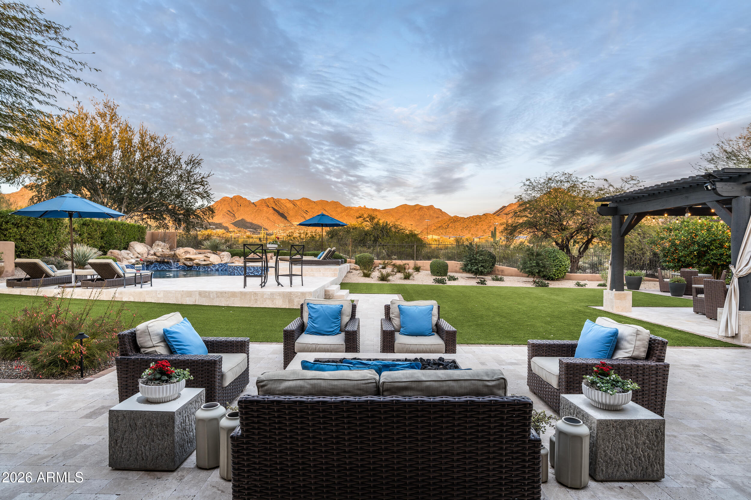 Exquisite Living in Camelot Haciendas at DC Ranch
This 4,707 SF, 4-bedroom, 4-bath residence is beautifully remodeled and nestled within the gated Camelot Haciendas at DC Ranch. Situated on a generous 16,665 sq. ft. lot with stunning McDowell Mountain views and a wash directly behind the home, it offers privacy and unobstructed vistas. The east-facing backyard features a sparkling pool and spa, lush turf, and multiple seating areas--perfect for morning coffee, evening sunsets, or entertaining at any hour.
Inside, the home exudes sophistication with wide-plank white oak floors and an open-concept layout. The chef's kitchen boasts quartzite counters, Wolf/Sub-Zero appliances, and abundant storage, flowing seamlessly into the dramatic great room with soaring ceilings. A custom wine wall leads to a private courtyard, creating a serene retreat at the heart of the home.
The first-floor primary suite offers a sitting area overlooking the mountains, complemented by a spa-inspired bath. Upstairs, three additional bedrooms--including one en-suite with a Juliet balcony--and two full baths provide comfort and privacy for family or guests. Recent upgrades, including newer AC units, ensure efficiency and year-round comfort.
Residents enjoy access to the DC Ranch Community Center with pools, fitness, tennis, and a vibrant calendar of events. Just a short walk to DC Ranch Marketplace, dining, golf, hiking, and top-rated schools, this home offers the perfect combination of privacy, style, and the unparalleled North Scottsdale lifestyle.