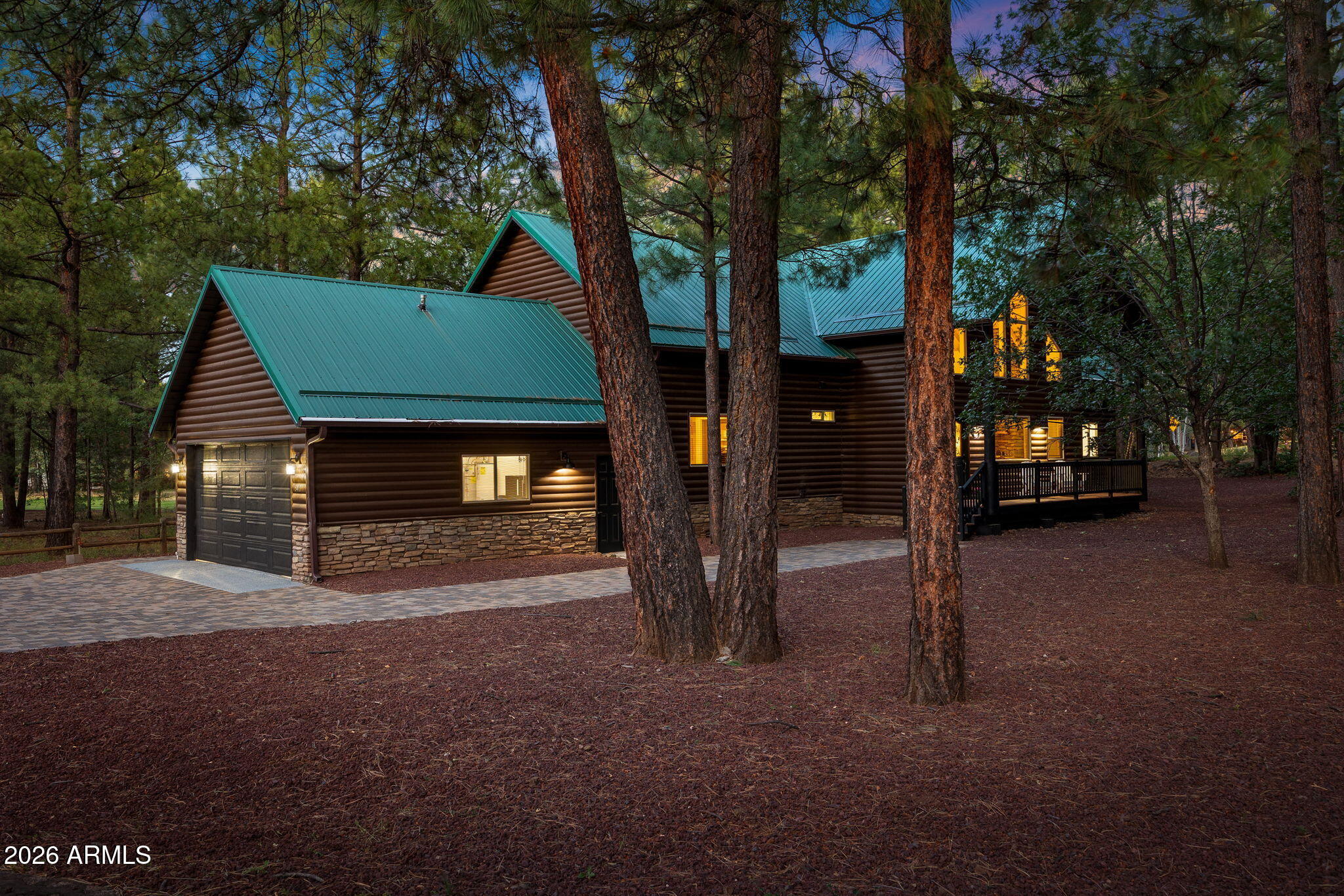 Experience mountain luxury and serene golf course living in this spacious 5-bedroom, 6-bathroom home located in the highly sought-after Pinetop Lakes Golf & Country Club community. With 3 en-suites located on the main floor, each bedroom features its own private en-suite bathroom, providing exceptional comfort and privacy for family and guests. This beautifully updated home offers numerous recent improvements, including brand-new stainless steel appliances with a double oven, a new front-load washer and dryer, new carpet throughout, fresh exterior trim paint, a durable epoxy-coated garage floor, and a new paver driveway with sidewalks that extend around the property! Step inside to discover soaring vaulted ceilings and an open, sun-filled living area anchored by a stunning stone fireplace, creating the perfect setting for cozy mountain gatherings. The thoughtfully designed floor plan features both a main-level living room and an additional upstairs living space, offering flexibility for entertaining, relaxing, or hosting overnight guests. The inviting kitchen provides generous counter space, a large pantry, and an adjoining dining area that flows seamlessly outdoors. A sliding glass door opens to an expansive covered patio framed by a dramatic two-story roofline, where you can enjoy lush golf course views of the 18th tee box leading to the fairway. Additional highlights include a spacious laundry room with bonus space ideal for a home office, craft room, or additional storage, along with a two-car garage. Pinetop Lakes Golf & Country Club features an 18-hole executive-style golf course that is open to the public, while optional memberships provide access to the driving range, practice greens, dining, social events, tennis, and pickleball courts. This exceptional property combines thoughtful updates, generous living spaces, and an unbeatable mountain lifestyle in one of Pinetop's most desirable communities.