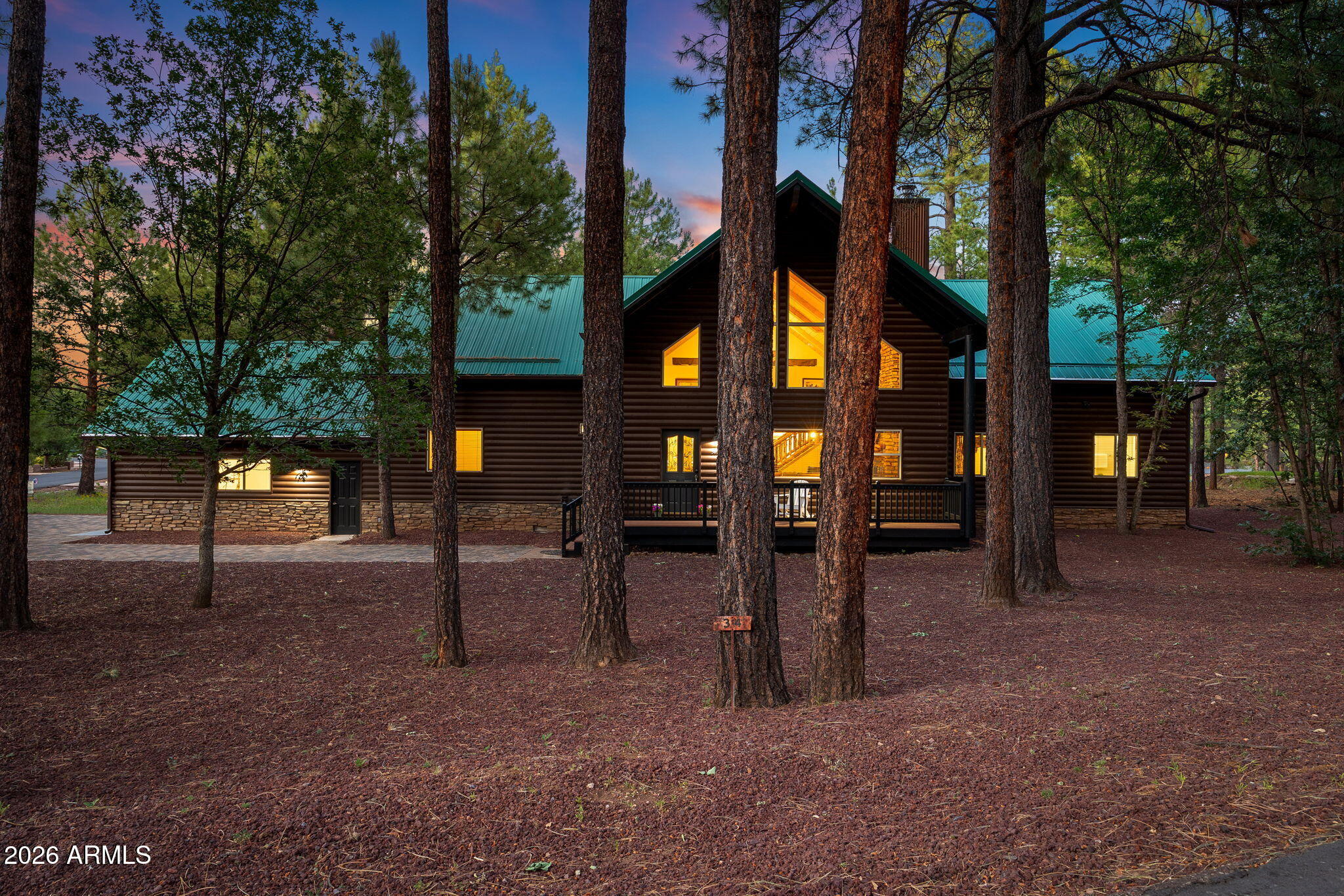 Experience mountain luxury and serene golf course living in this spacious 5-bedroom, 6-bathroom home located in the highly sought-after Pinetop Lakes Golf & Country Club community. With 3 en-suites located on the main floor, each bedroom features its own private en-suite bathroom, providing exceptional comfort and privacy for family and guests. This beautifully updated home offers numerous recent improvements, including brand-new stainless steel appliances with a double oven, a new front-load washer and dryer, new carpet throughout, fresh exterior trim paint, a durable epoxy-coated garage floor, and a new paver driveway with sidewalks that extend around the property! Step inside to discover soaring vaulted ceilings and an open, sun-filled living area anchored by a stunning stone fireplace, creating the perfect setting for cozy mountain gatherings. The thoughtfully designed floor plan features both a main-level living room and an additional upstairs living space, offering flexibility for entertaining, relaxing, or hosting overnight guests. The inviting kitchen provides generous counter space, a large pantry, and an adjoining dining area that flows seamlessly outdoors. A sliding glass door opens to an expansive covered patio framed by a dramatic two-story roofline, where you can enjoy lush golf course views of the 18th tee box leading to the fairway. Additional highlights include a spacious laundry room with bonus space ideal for a home office, craft room, or additional storage, along with a two-car garage. Pinetop Lakes Golf & Country Club features an 18-hole executive-style golf course that is open to the public, while optional memberships provide access to the driving range, practice greens, dining, social events, tennis, and pickleball courts. This exceptional property combines thoughtful updates, generous living spaces, and an unbeatable mountain lifestyle in one of Pinetop's most desirable communities.