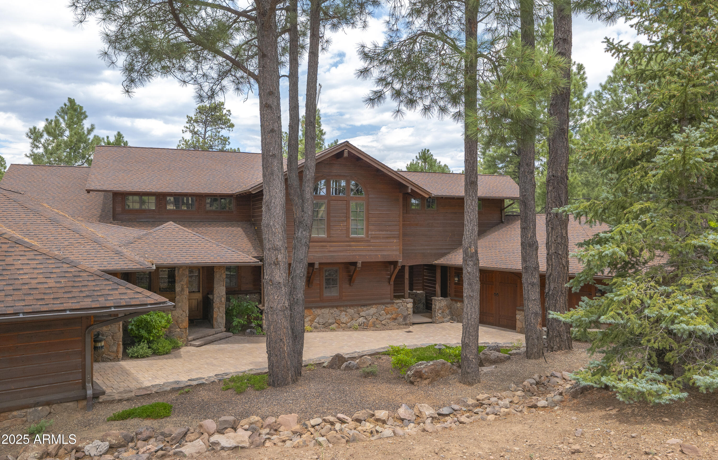 A mountain masterpiece majestically perched high above the 16th hole of the Meadow Golf course at Forest Highlands with panoramic views of Ponderosa Pines and views of the San Francisco Peaks.  Stunning craftsmanship with top of the line finishes throughout.  Spectacular entertaining spaces on both levels with multiple family rooms, multiple decks and seating areas, firepit, full bar plus an additional wet bar downstairs and multiple built-in BBQ grills. In addition to the 5 bedrooms, there is a large office with views, a fitness room and another large bedroom/office combo room with versatility. The chef's kitchen is centrally located with direct access to the great room and large covered deck.  Top it off with central A/C and a 4-car garage! Tucked away amidst 1,100 acres of pristine alpine beauty, Forest Highlands exudes an unparalleled sense of exclusivity and serenity. With two championship golf courses designed by Tom Weiskopf and Jay Morrish, Forest Highlands sets the stage for unforgettable golf experiences. The community offers an array of exceptional amenities, including two clubhouses, multiple dining options, tennis courts, swimming pools, and miles of hiking and biking trails. Forest Highlands is a retreat where luxury meets nature, ensuring a harmonious lifestyle for its residents.