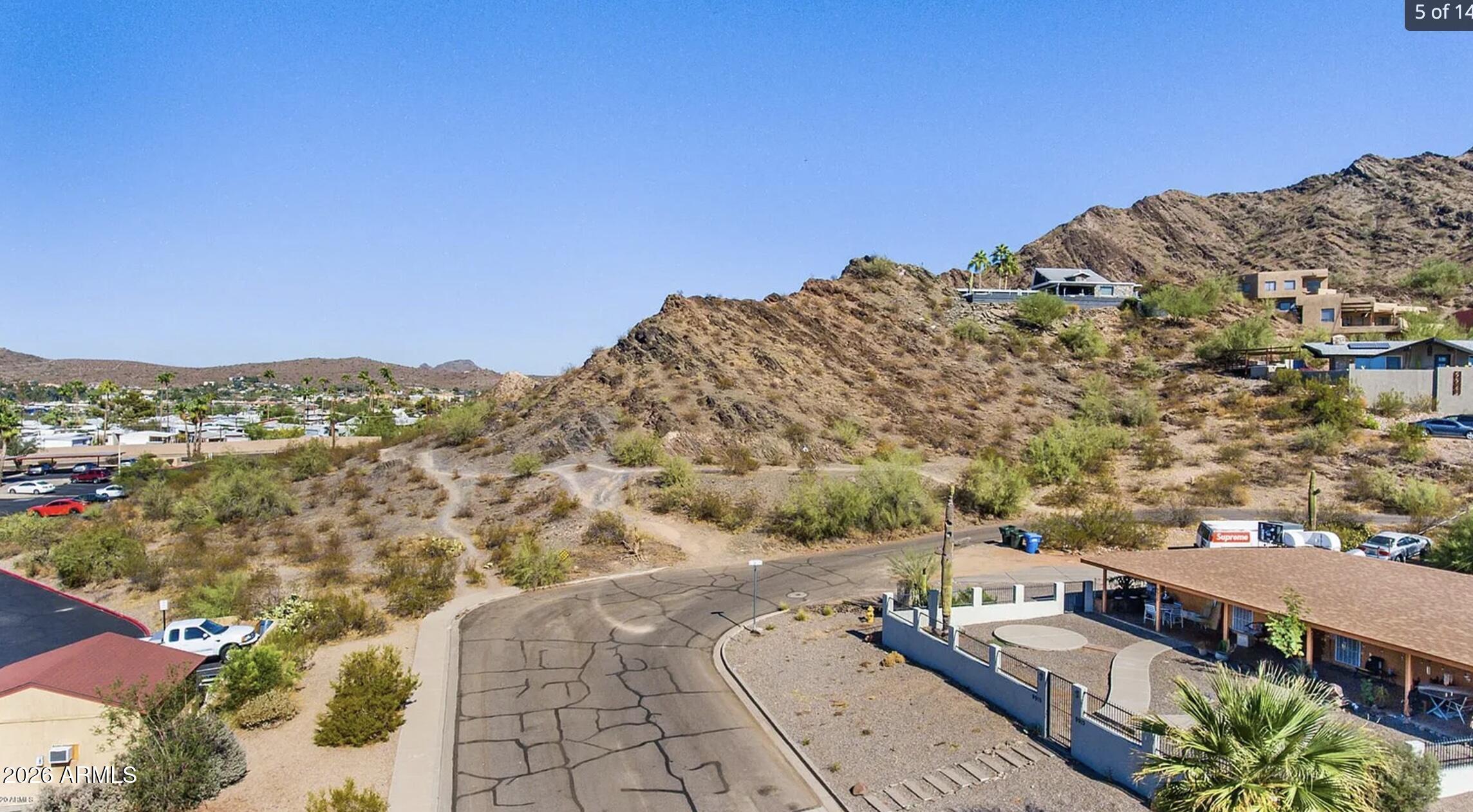 Set within the secluded hillside enclave of Ocotillo Hills, 9935 N 16th Place E #69 presents a rare opportunity to create a custom residence in one of North Central Phoenix's most quietly prestigious pockets. Perched on approximately half an acre with dramatic elevation, the homesite captures sweeping mountain silhouettes, shimmering city lights, and the kind of Arizona sunsets that transform every evening into an experience. Surrounded by architecturally distinctive custom estates and luxury hillside homes, this address offers a refined balance of privacy and connectivity. The terrain and orientation lend themselves naturally to a sophisticated modern desert design--expansive glass walls, resort-style outdoor living, and seamless indoor-outdoor flow that embraces the Sonoran landscape. Nearby hiking trails, mature desert vegetation, and the peaceful character of the neighborhood create a sense of retreat rarely found this close to the city's premier dining, golf, shopping, and business corridors.

This is a setting for buyers who value discretion, topography, and the enduring appeal of elevated desert living. In a market where exceptional homes are defined as much by their surroundings as their design, this property offers the foundation for a residence perfectly aligned with the luxury lifestyle that defines the North Mountain corridor.  Homes located on this mountainside are valued at 800k-1.2 million.