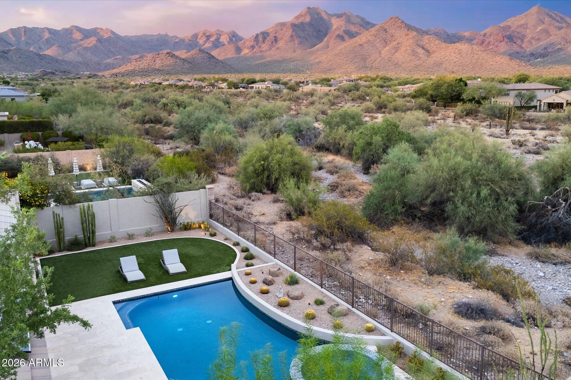 PANORAMIC MOUNTAIN VIEWS, inside and out. Welcome to 17735 N 97th Way, a pristine residence on a premium view lot in Windgate Ranch, one of North Scottsdale's most sought-after guard-gated communities. The home's orientation captures sweeping mountain views from the great room, kitchen, primary suite, and backyard, making the setting one of the property's most defining and memorable features. Offering 3,472 square feet, this split, great room floor plan features 4 bedrooms and 3.5 bathrooms, plus a den, versatile bonus room, and 3 car garage. Major system upgrades add meaningful long-term value, including a high-end HVAC system (2026) with a 10-year warranty and a 19kW solar system. These improvements complement the home's pristine condition and reinforce the quality of care throughout. From the moment you start your approach, the home reflects meticulous ownership and a level of care that is immediately apparent. Fresh exterior paint (2025) and recent flooring provide a refined canvas, while the great room's expansive view-facing windows draw the McDowell Mountains into daily living. Warm modern finishes, newer construction, and a thoughtful layout create a home that feels both elevated and comfortable.

The kitchen is beautifully appointed with Sub-Zero and Wolf appliances, generous counter space, abundant cabinetry, a large walk-in pantry, and a seamless connection to the main living area. Designed for both everyday function and effortless entertaining, the kitchen anchors the home with quality, scale, and an easy relationship to the surrounding living spaces.

The backyard is extraordinary and must be experienced in person. Designed around the McDowell Mountain backdrop, the outdoor living space features a heated saltwater pool, spa, covered patio, fire pit, and a Lynx BBQ added in 2025. Whether enjoying quiet morning light, dramatic desert sunsets, warm summer days by the pool, or evening gatherings with loved ones, this setting encapsulates the North Scottsdale lifestyle at its best.

Major system upgrades add meaningful long-term value, including a high-end HVAC system replaced in 2026 with a 10-year warranty, a water heater replaced in 2024, and a 19kW solar system. These important improvements complement the home's pristine condition and further reinforce the quality of care found throughout the property.

Windgate Ranch is known for its prestigious resort-style lifestyle, offering residents an impressive collection of amenities, community spaces, recreational opportunities, and an active social calendar. With a guard-gated setting, beautiful streetscapes, pools, fitness and sport amenities, parks, trails, gathering areas, and year-round neighborhood events, Windgate Ranch delivers a connected North Scottsdale lifestyle in a setting that continues to be highly desirable.

A newer, updated Windgate Ranch home with panoramic McDowell Mountain views, a premium lot, heated saltwater pool and spa, solar, and recent major system upgrades is exceptionally rare. This home is even more beautiful in person and truly must be seen to be appreciated. Come see it today.