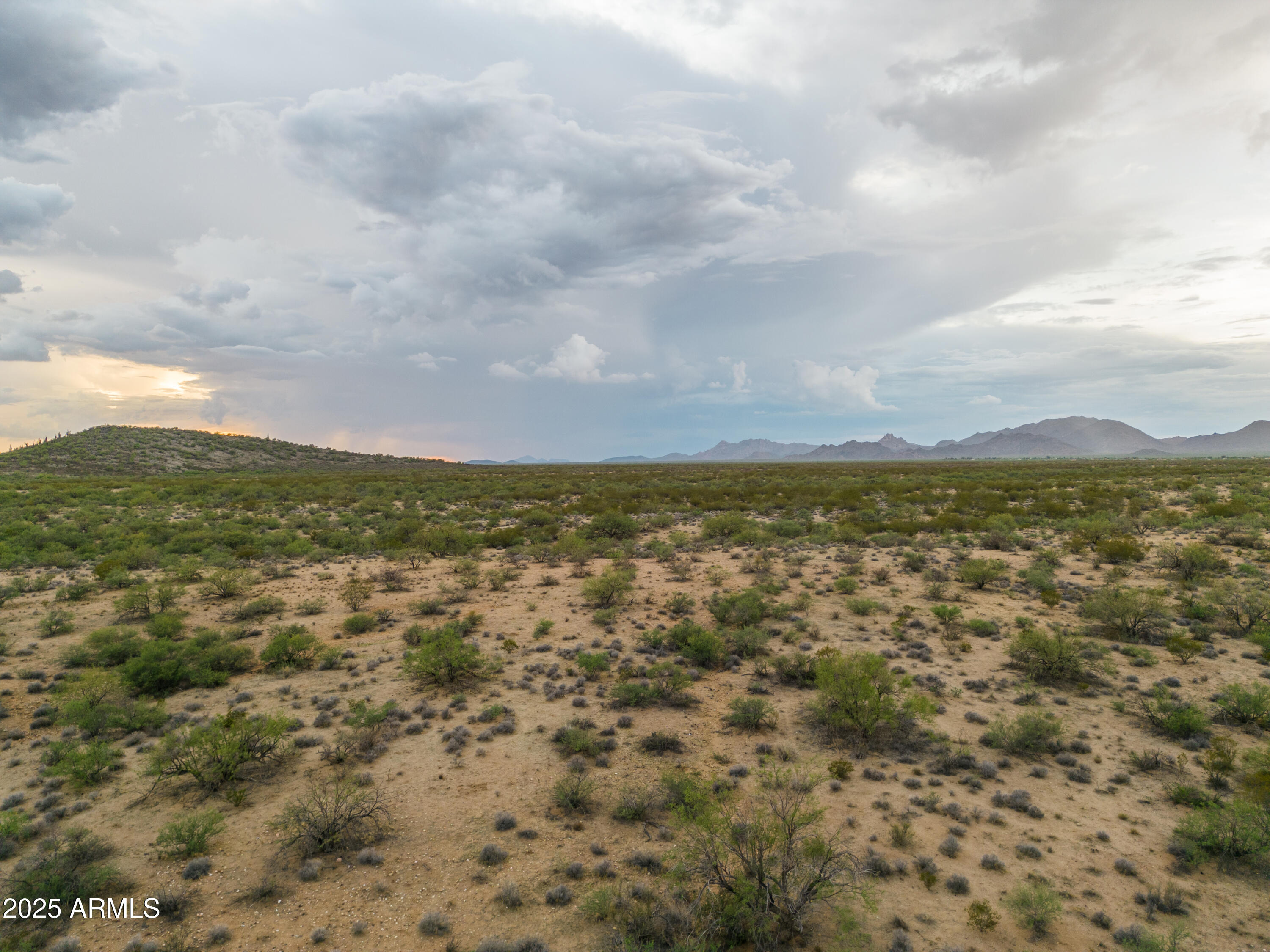 10 beautiful acres, shared well, custom home area with state land at the back door.  This is for the buyer who has champagne taste and wants to live in a secluded, low density area.  Easy access to the major Hwy to get to Prescott, Las Vegas, Wickenburg or California.  The rains have come and the desert floor is beautiful again with mesquite trees and loaded with wildlife.  Good footing for the horses, award winning school for the kids and small town hospitality. The 10 can be split once. Builder assistance available as well or will subordinate for builder spec.  Ask about owner financing.