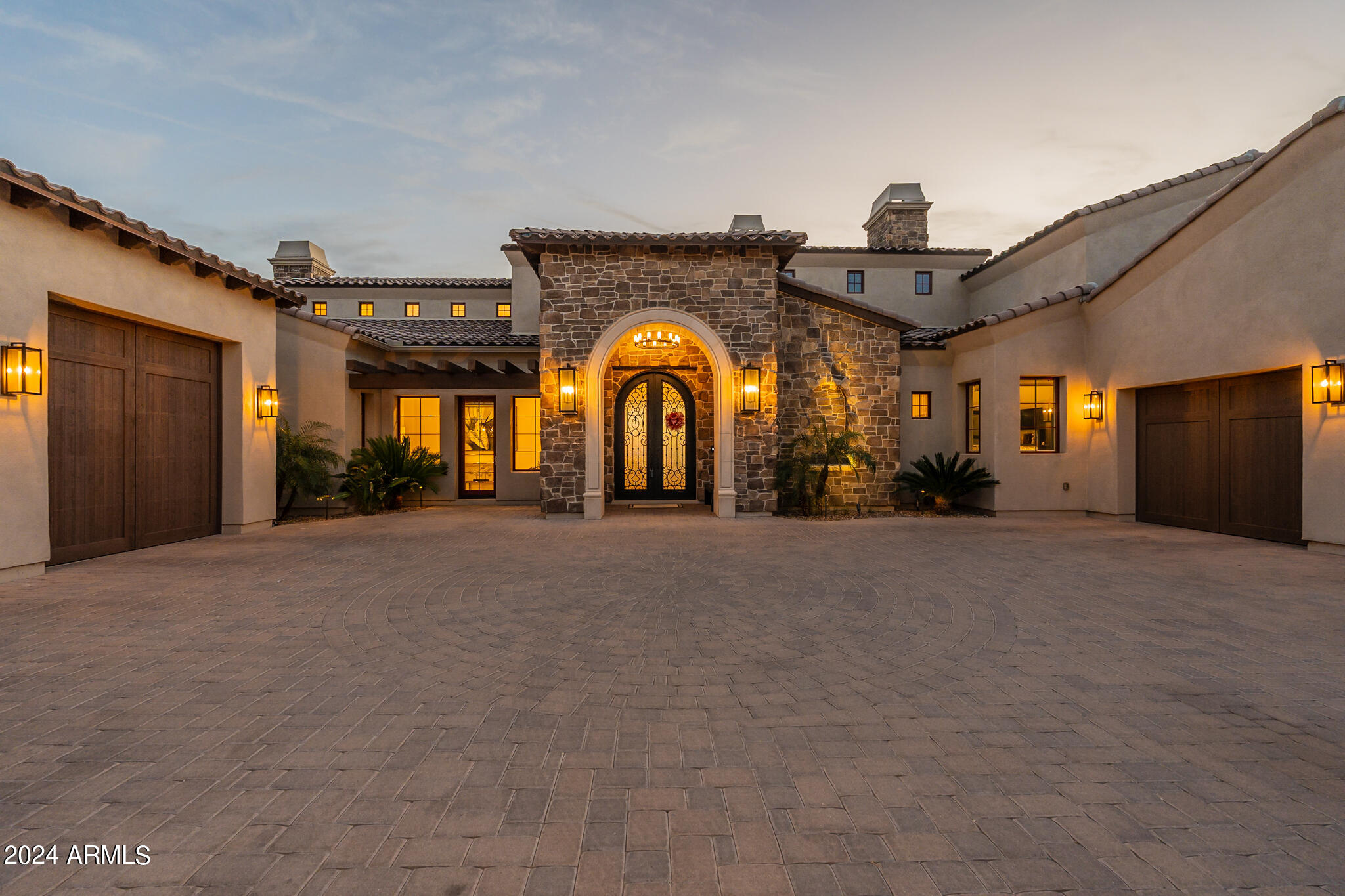 Exquisite Custom Home with Breathtaking Views in Firerock Country Club.Discover timeless elegance and impeccable design in this stunning custom home nestled within the prestigious Firerock Country Club. From the moment you step through the front door, you'll be captivated by the seamless blend of luxury, comfort, and awe-inspiring vistas. Enjoy sweeping city lights and panoramic mountain views from nearly every room. Whether you're relaxing in the living area, preparing meals in the gourmet kitchen, or unwinding in the master retreat, the scenery is a constant companion.The large living area boasts a marble slabbed fireplace and a picture-framed TV, creating an inviting ambiance for gatherings and quiet evenings alike.Culinary enthusiasts will appreciate the enormous butler's pantry, top-of-the-line Thermador appliances, and a 6-burner gas stove with a griddle. Custom chandeliers add a touch of elegance. Host unforgettable game nights in the giant game room, complete with a kitchenette/bar, kegerator, and soaring marble fireplace. There's ample space for a pool table or multiple game tables.: Your private oasis awaitsa primary  suite unlike any other. Cozy up by the fireplace and read a book or unwind in the soaker tub. Dual water closets, large closet  and direct access to the laundry room enhance convenience. Oversize laundry room with lots of storage and dog bath. The 9 and 10-foot garage doors, J Shaft for car lifts, reinforced concrete, 220W power, and climate-controlled storage room cater to car lovers. Built in cabinets and work space are an added bonus. Beautiful guest bedrooms with en suite bathrooms, and a hidden loft for imaginative play. Separate living space for extended family or guests, complete with a kitchenette. Elan Smart home features for modern convenience. A room that can be used by wine enthusiasts or can be used as a flex room.Indulge in the epitome of luxury living, where every detail has been meticulously crafted to enhance your lifestyle.
