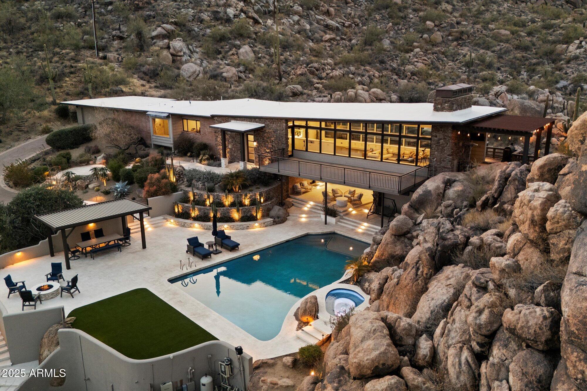 VIEWS, VIEWS, and MORE VIEWS from this one of a kind estate by Gerry Jones. Nestled on a boulder studded 5-acre lot along Black Mountain's eastern face. Enjoy stunning views in all directions from the home, decks, and patios. From sunrise to sunset, enjoy the peaceful tranquility of this stunning modern architectural gem.  Extensive renovations include the resort-style pool, jacuzzi, tennis court and landscaping. Lower level completely remodeled with new bathroom and floors. New HVAC's throughout. This mid-century home is a rare find—preserve its timeless character or modernize it to today's look. Enjoy the Carefree lifestyle in a simply unparalleled setting. Artfully intimate with timeless sophistication.  Complete with Guest House, 4 car-garage and private lookout. NO HOA and LOW TAXES!