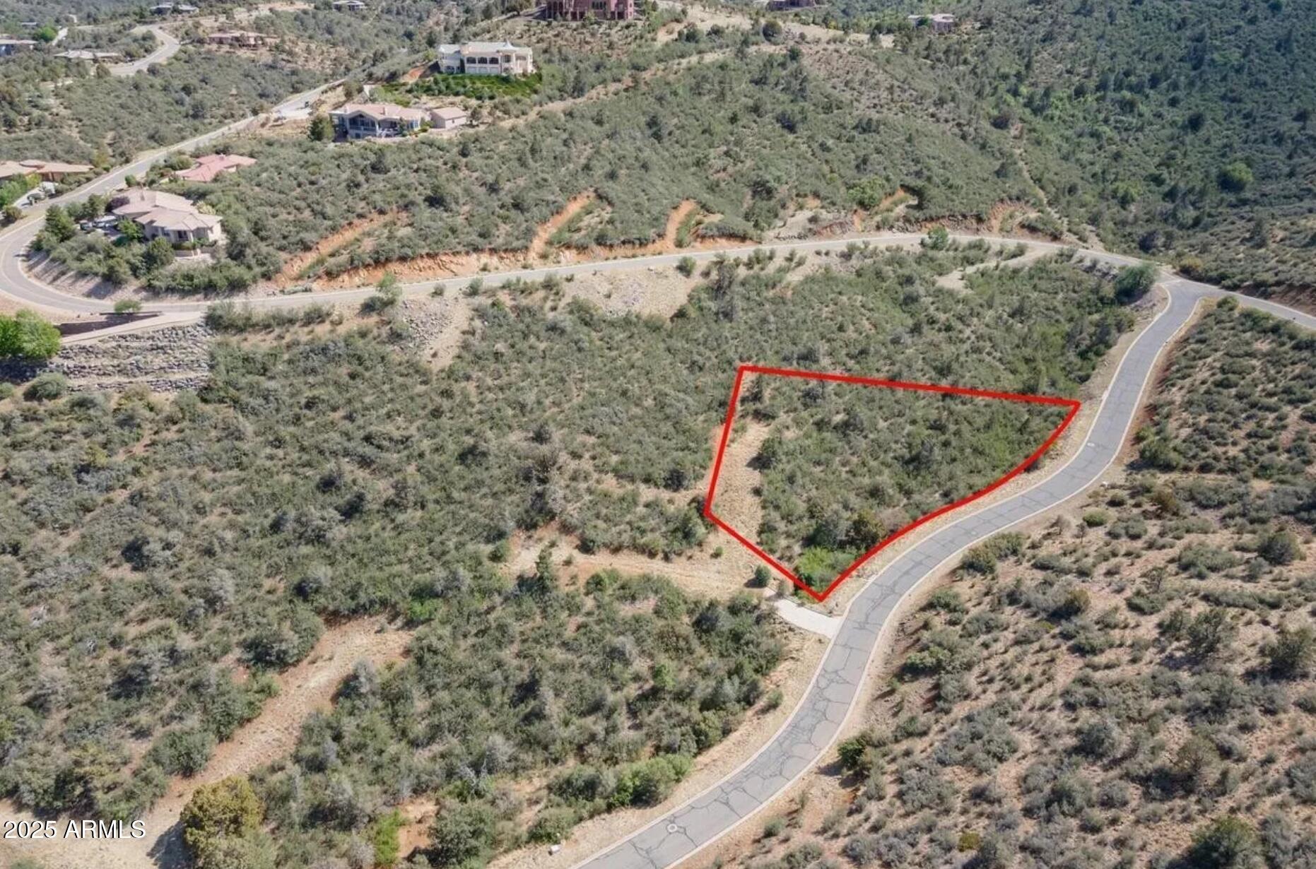 Secluded 1-acre lot with sweeping mountain views in the desirable Ranch at Prescott community. This private parcel offers a peaceful setting surrounded by mature pines and custom homes. All utilities are available underground and can be brought onto the property, including city water, sewer, and natural gas (buyer to verify). The generous lot size provides ample space for your dream residence. Just 13 minutes from downtown Prescott, enjoy quick access to shopping, dining, and recreation while savoring the privacy of this hillside retreat. Rare chance to own over an acre in one of Prescott's most sought-after neighborhoods. Seller offering discount if purchased with adjacent parcel 112-01-074. Owner is a licensed real estate agent in Arizona.