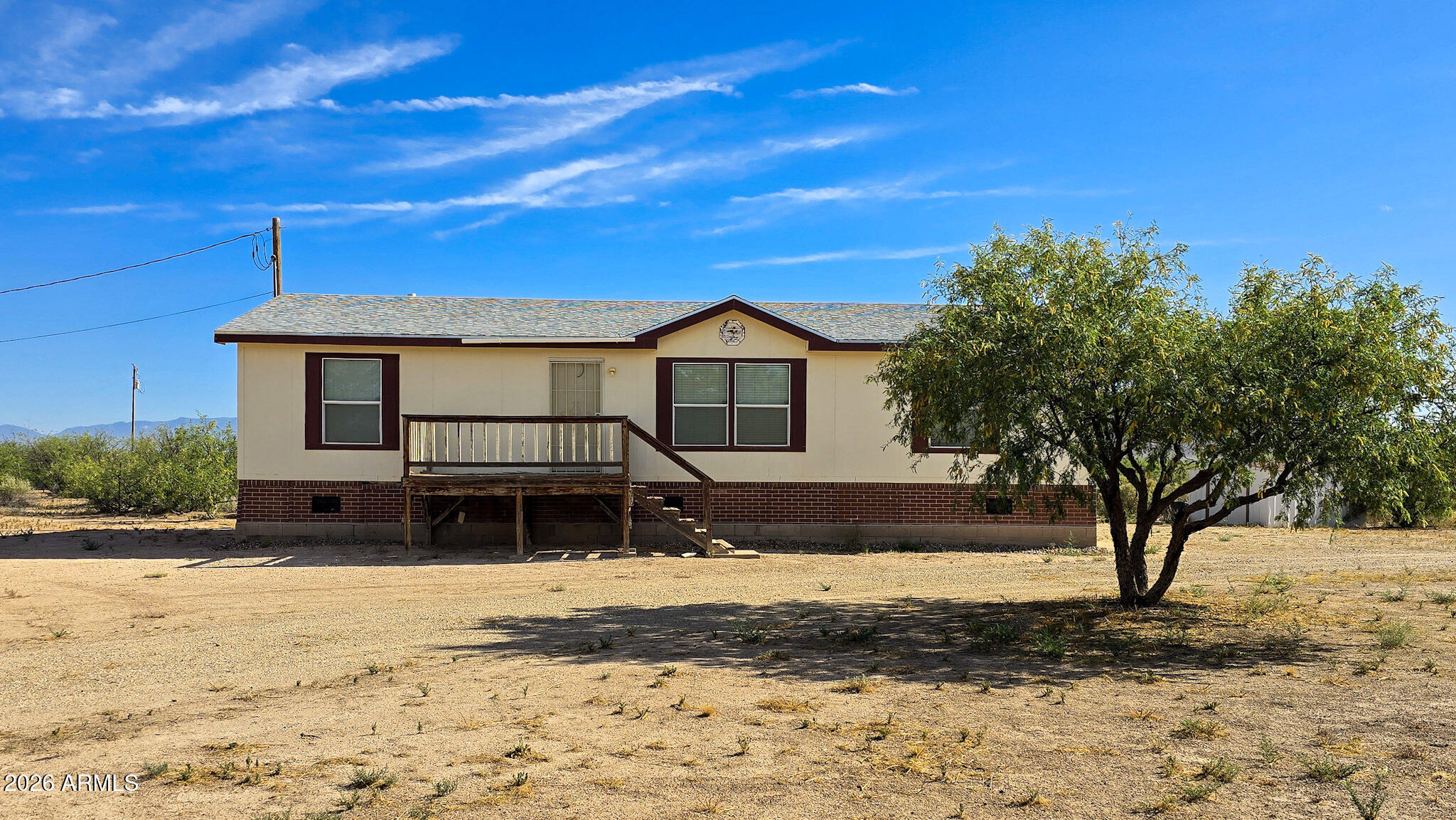 2004 manufactured home, 1,377 sq ft on 4 acres, 3 bedrooms, 2 bathrooms. This property offers rural living with room to spread out, shared well, a shared driveway, and a barbed wire gate that will allow for separate driveway access if desired. Recent survey and new legal description available due to recent land split. Front porch and back stairs need attention; seller is willing to consider a concession but will not complete replacement prior to closing. Washer and dryer are included; washer does not currently work.  The home is currently not affixed but is intended to be affixed as part of closing, subject to applicable requirements.